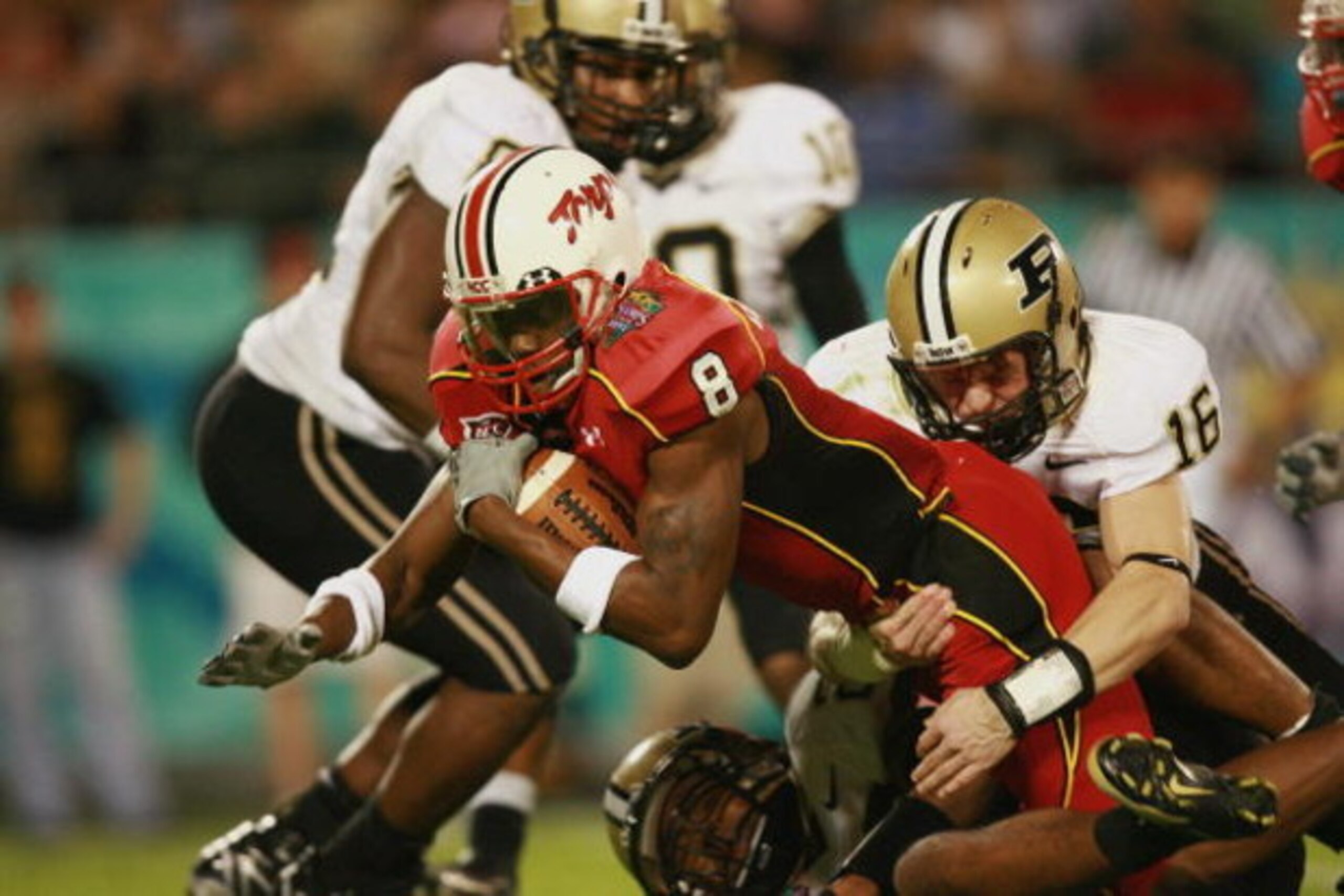 ORLANDO, FL - DECEMBER 29:  Wide receiver Darrius Heyward-Bey #8 of the Maryland Terrapins stretches for yardage against safety Brandon Erwin #16 of the Purdue Boilermakers in the Champs Sports Bowl at Florida Citrus Bowl on December 29, 2006 in Orlando, 
