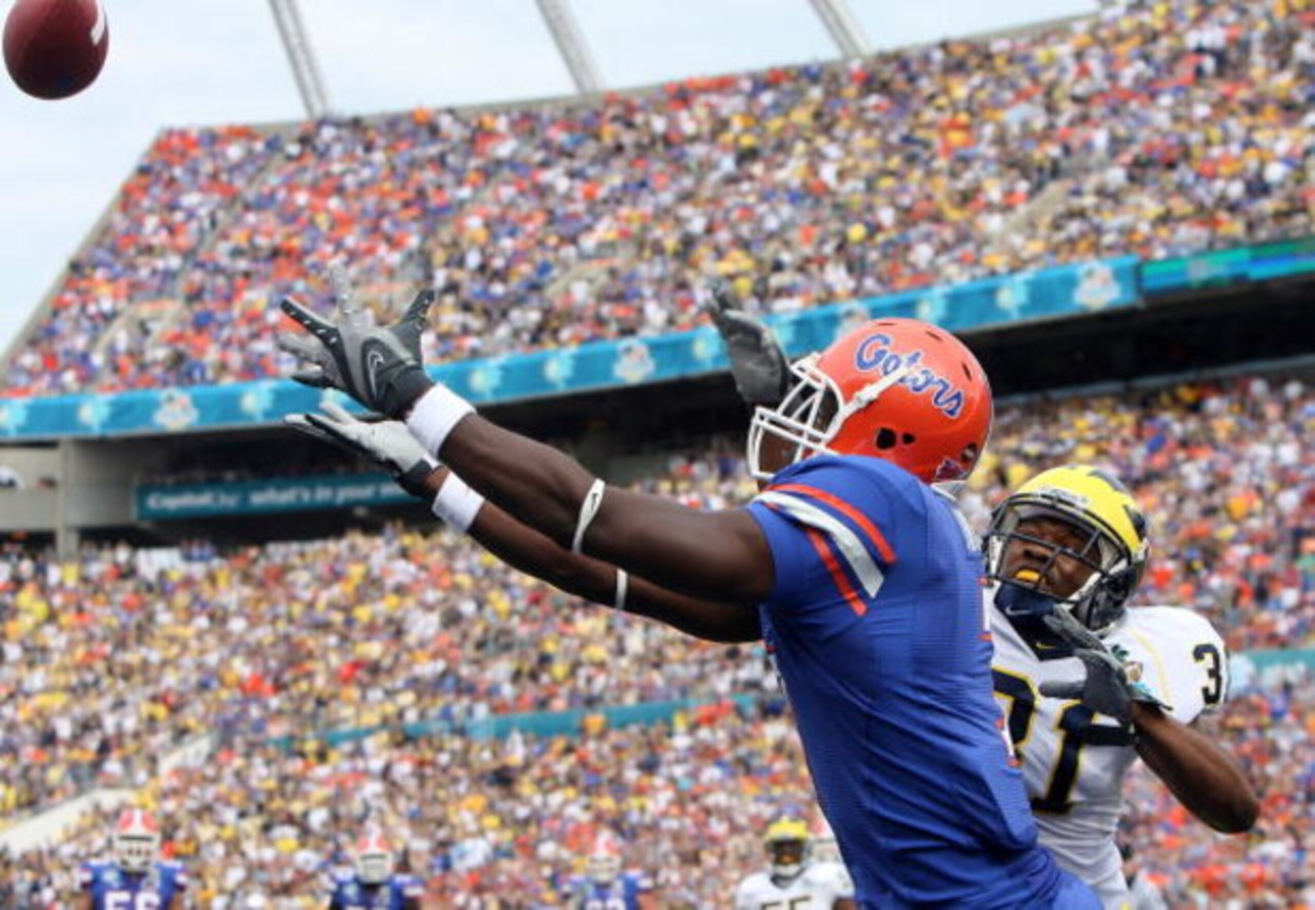 ORLANDO, FL - JANUARY 01:  Safety Brandent Englemon #31 of the Michigan Wolverines defends as tight end Cornelius Ingram #7 of the Florida Gators tries to haul in a reception in the Capital One Bowl at Florida Citrus Bowl on January 1, 2008 in Orlando, Fl