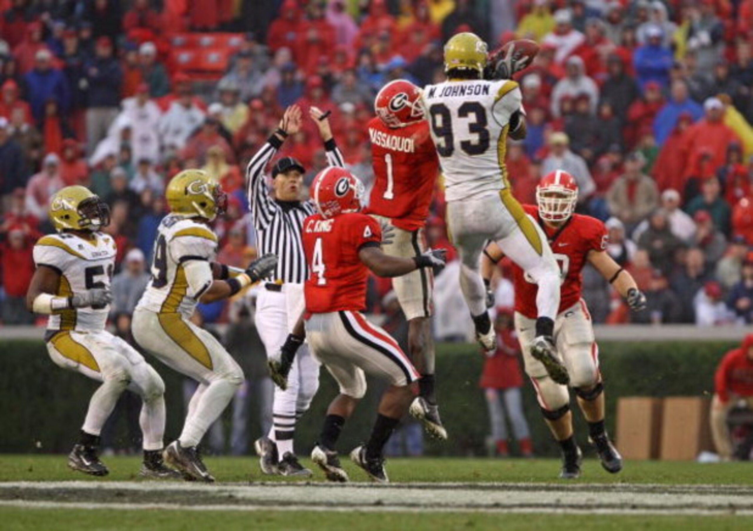 ATHENS, GA - NOVEMBER 29:  Wide receiver Mohamed Massaquoi #1 of the Georgia Bulldogs and defensive end Michael Johnson #93 of the Georgia Tech Yellow Jackets collide while trying to catch an errant pass during the game at Sanford Stadium on November 29, 