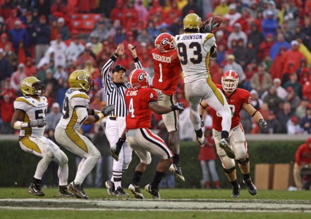 ATHENS, GA - NOVEMBER 29:  Wide receiver Mohamed Massaquoi #1 of the Georgia Bulldogs and defensive end Michael Johnson #93 of the Georgia Tech Yellow Jackets collide while trying to catch an errant pass during the game at Sanford Stadium on November 29, 