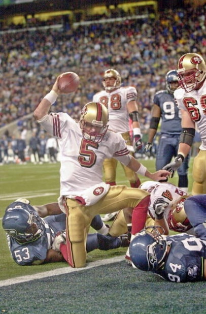 SEATTLE - OCTOBER 12:  Quarterback Jeff Garcia #5 of the San Francisco 49ers spikes the ball after scoring a touchdown against the Seattle Seahawks on October12, 2003 at Seahawks Stadium in Seattle, Washington.  (Photo by Otto Greule Jr/Getty Images)
