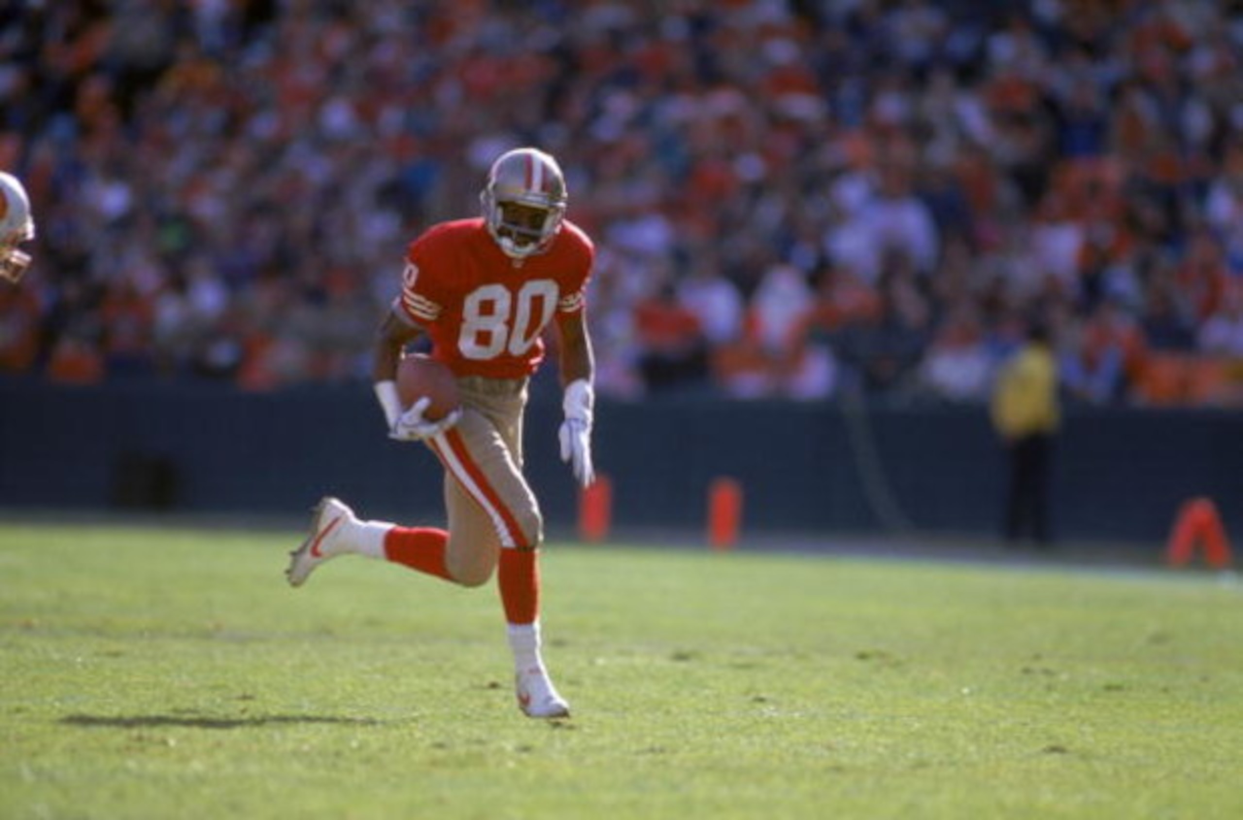 SAN FRANCISCO - DECEMBER 19: Wide receiver Jerry Rice #80 of the San Francisco 49ers runs with the ball during a game against the Tampa Bay Buccaneers at Candlestick Park on December 19, 1992 in San Francisco, California. The 49ers won 21-14. (Photo by SAN FRANCISCO - DECEMBER 19: Wide receiver Jerry Rice #80 of the San Francisco 49ers runs with the ball during a game against the Tampa Bay Buccaneers at Candlestick Park on December 19, 1992 in San Francisco, California. The 49ers won 21-14. (Photo by