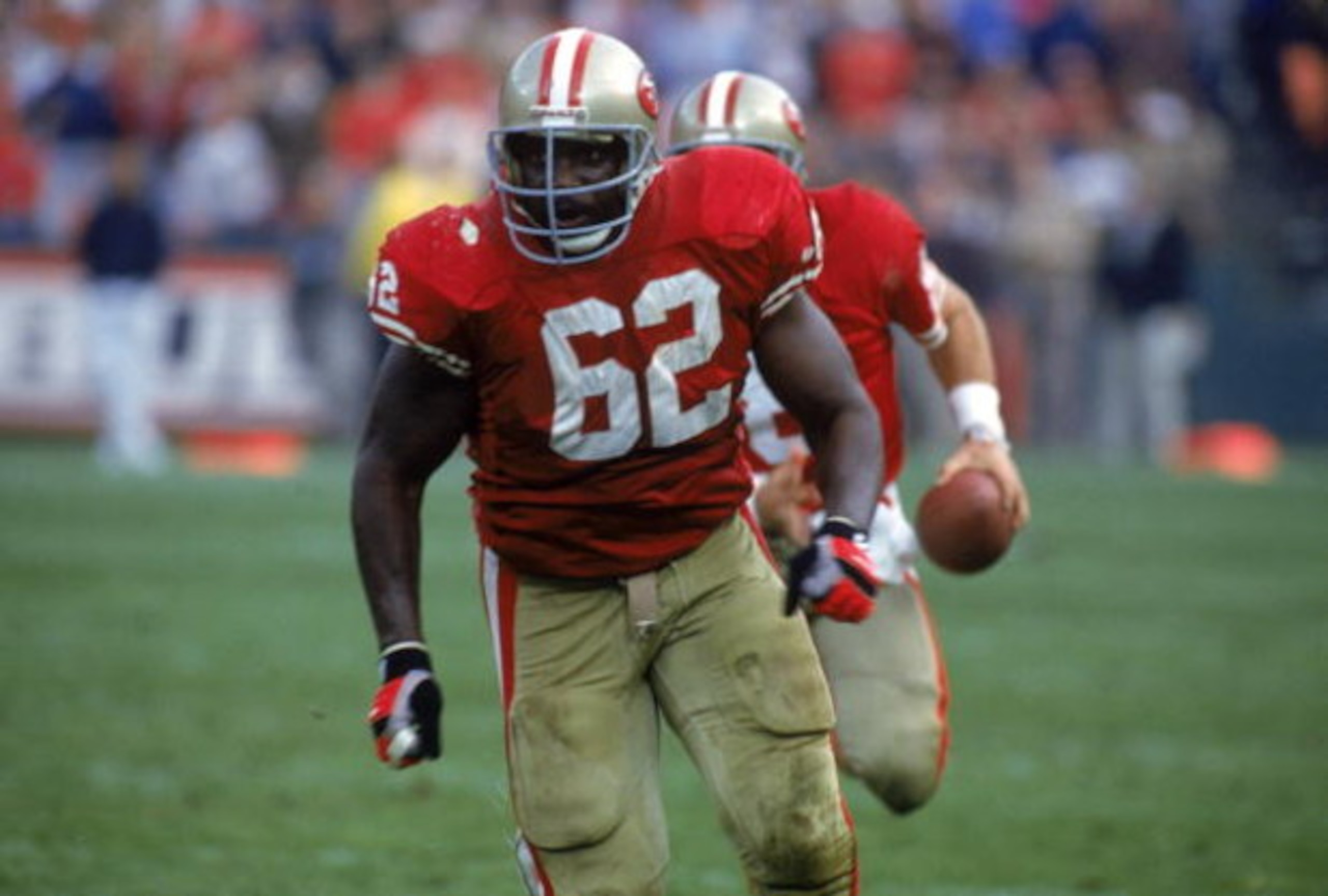 SAN FRANCISCO - NOVEMBER 15: Guard Guy McIntyre #62 of the San Francisco 49ers is the lead blocker for running quarterback Steve Young #8 during a game against the New Orleans Saints at Candlestick Park on November 15, 1992 in San Francisco, California. SAN FRANCISCO - NOVEMBER 15: Guard Guy McIntyre #62 of the San Francisco 49ers is the lead blocker for running quarterback Steve Young #8 during a game against the New Orleans Saints at Candlestick Park on November 15, 1992 in San Francisco, California.