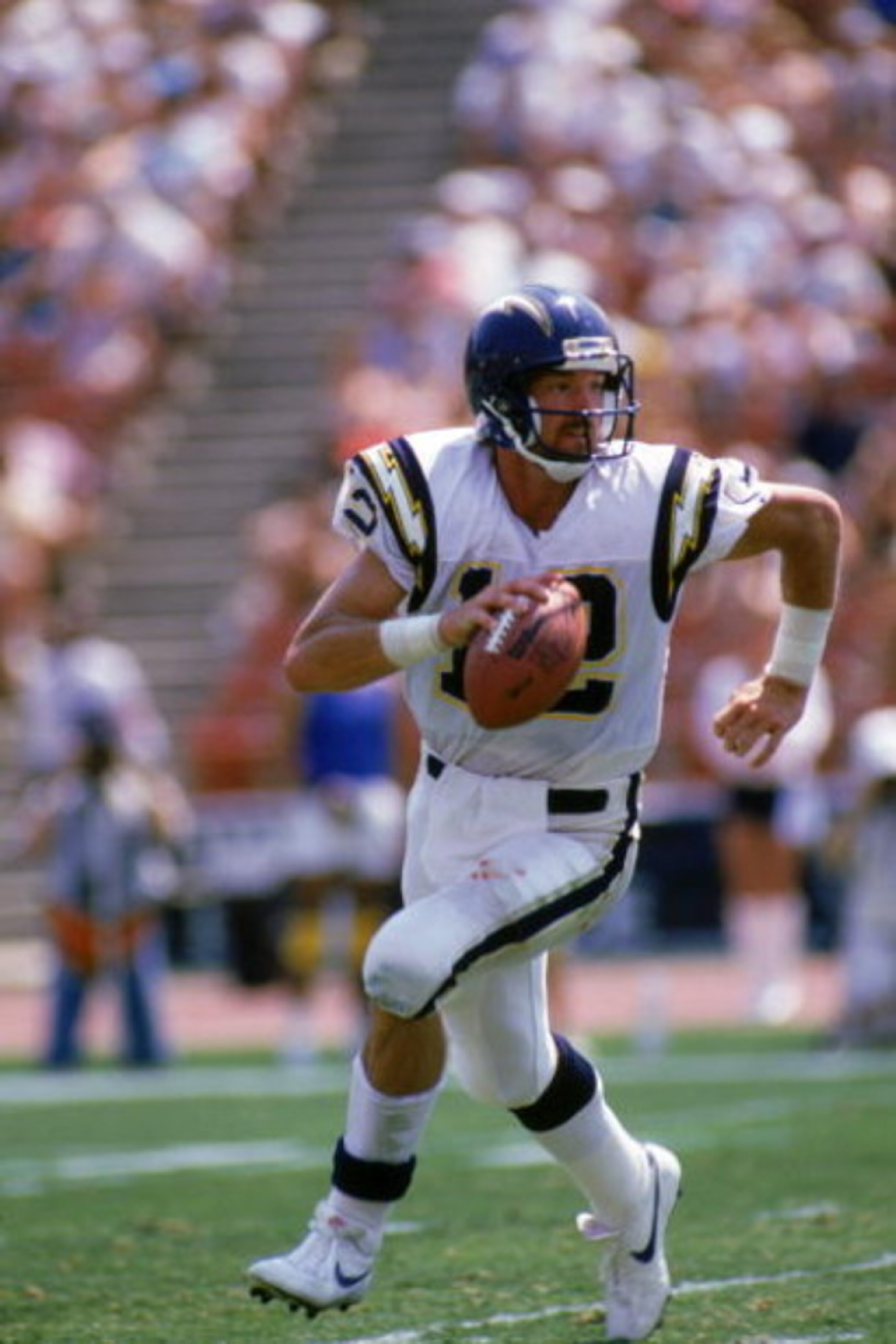 LOS ANGELES - SEPTEMBER 4: Quarterback Babe Laufenberg #12 of the San Diego Chargers runs with the ball during a game against the Los Angeles Raiders at the Los Angeles Memorial Coliseum on September 4, 1988 in Los Angeles, California. The Raiders won 2 LOS ANGELES - SEPTEMBER 4: Quarterback Babe Laufenberg #12 of the San Diego Chargers runs with the ball during a game against the Los Angeles Raiders at the Los Angeles Memorial Coliseum on September 4, 1988 in Los Angeles, California. The Raiders won 2