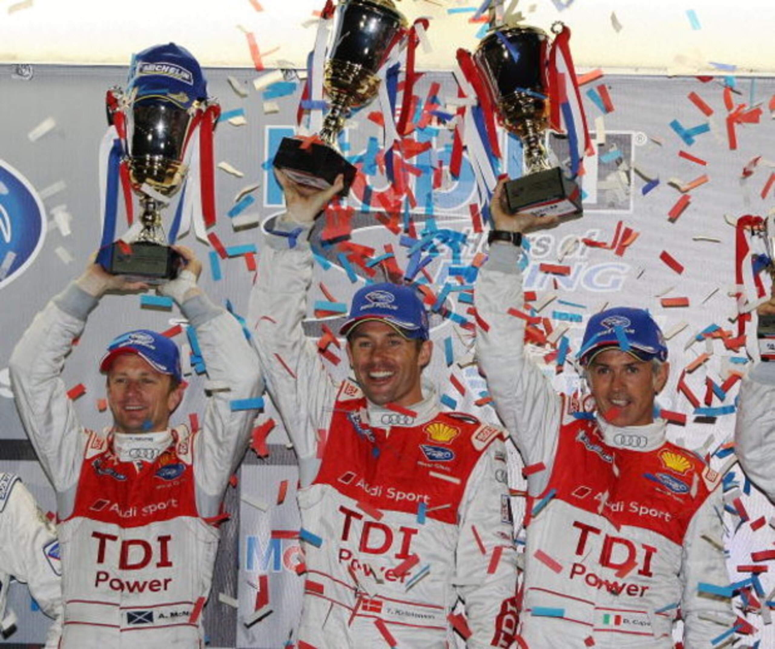 SEBRING, FL - MARCH 21:  (L-R) Allan McNish, Tom Kristensen and Rinaldo Capello of the #2 Audi Sport Team Joest Audi R15 TDI celebrate after their class and overall victory in the 57th Annual Mobil1 12 Hours of Sebring at Sebring International Raceway on 