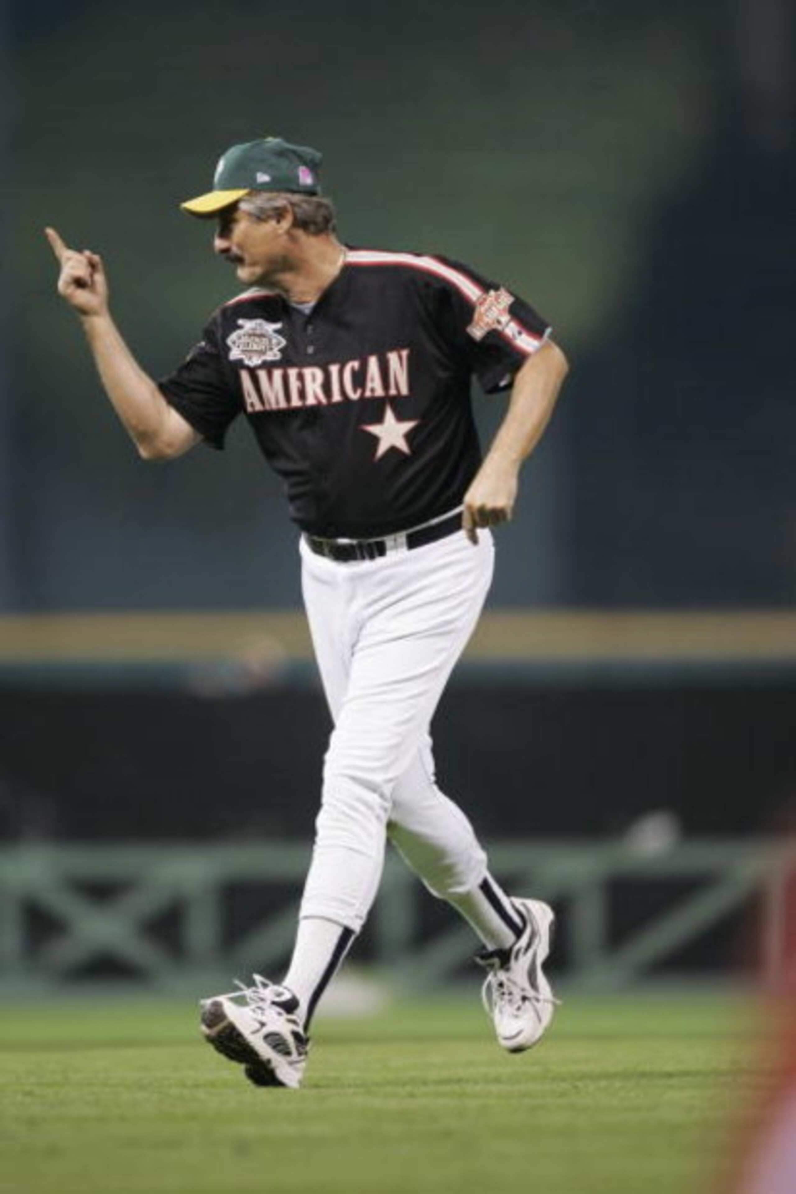 HOUSTON - JULY 11:  Rollie Fingers, Hall of Fame pitcher who played with the Oakland A's and San Diego Padres gestures as he runs on the field during the Major League Baseball Legends and Celebrity Softball Game at Minute Maid Park on July 11, 2004 in Hou