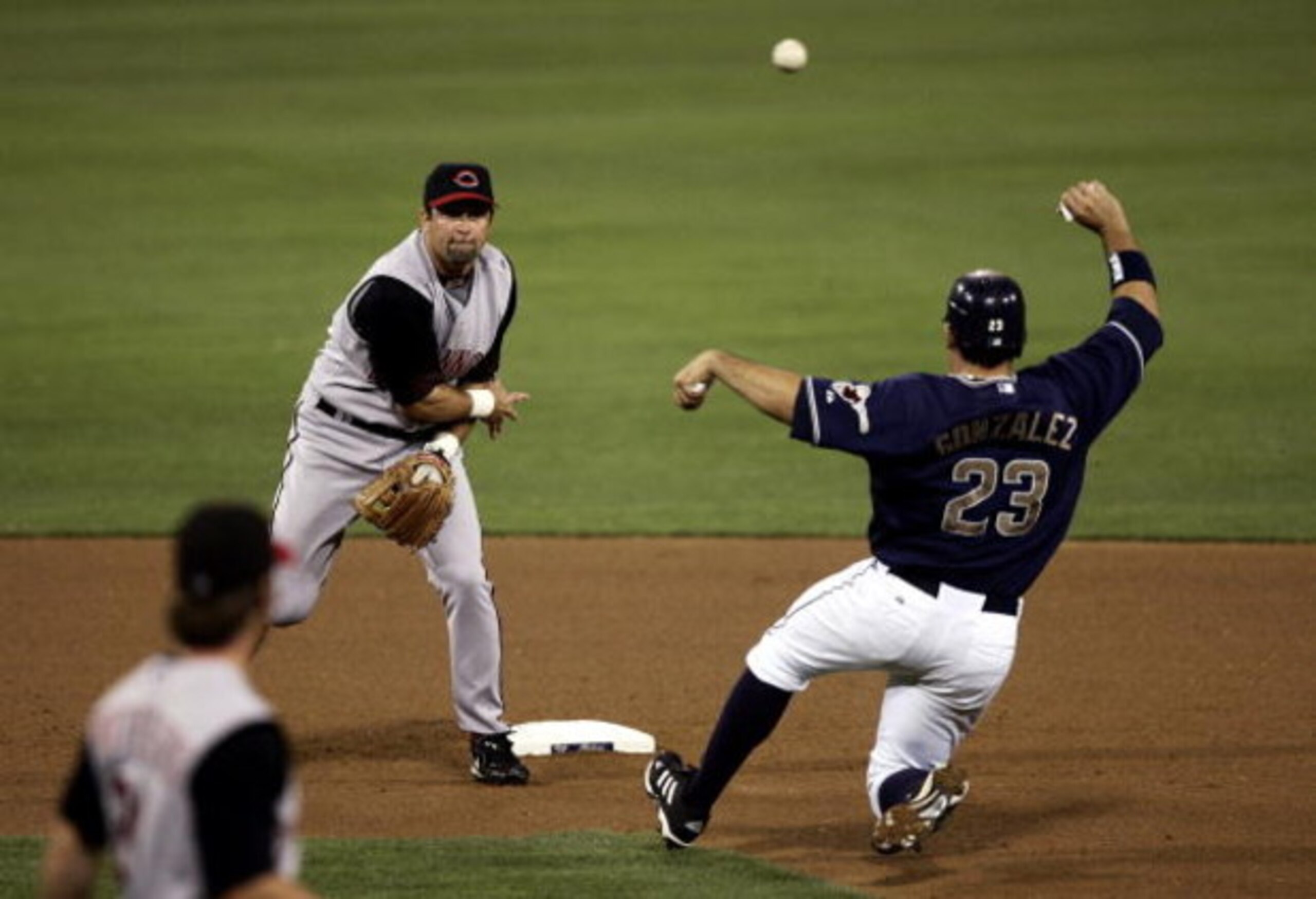 SAN DIEGO - SEPTEMBER 01:  Shortstop Rich Aurilia #33 of the Cincinnati Reds turns a double play as Adrian Gonzalez #23 of the San Diego Padres slides into 2nd base during their MLB Game at Petco Park on September 1, 2006 in San Diego, California.   (Phot