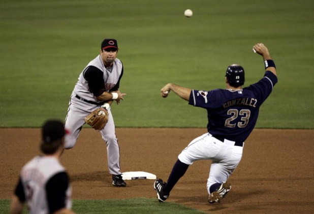 SAN DIEGO - SEPTEMBER 01:  Shortstop Rich Aurilia #33 of the Cincinnati Reds turns a double play as Adrian Gonzalez #23 of the San Diego Padres slides into 2nd base during their MLB Game at Petco Park on September 1, 2006 in San Diego, California.   (Phot