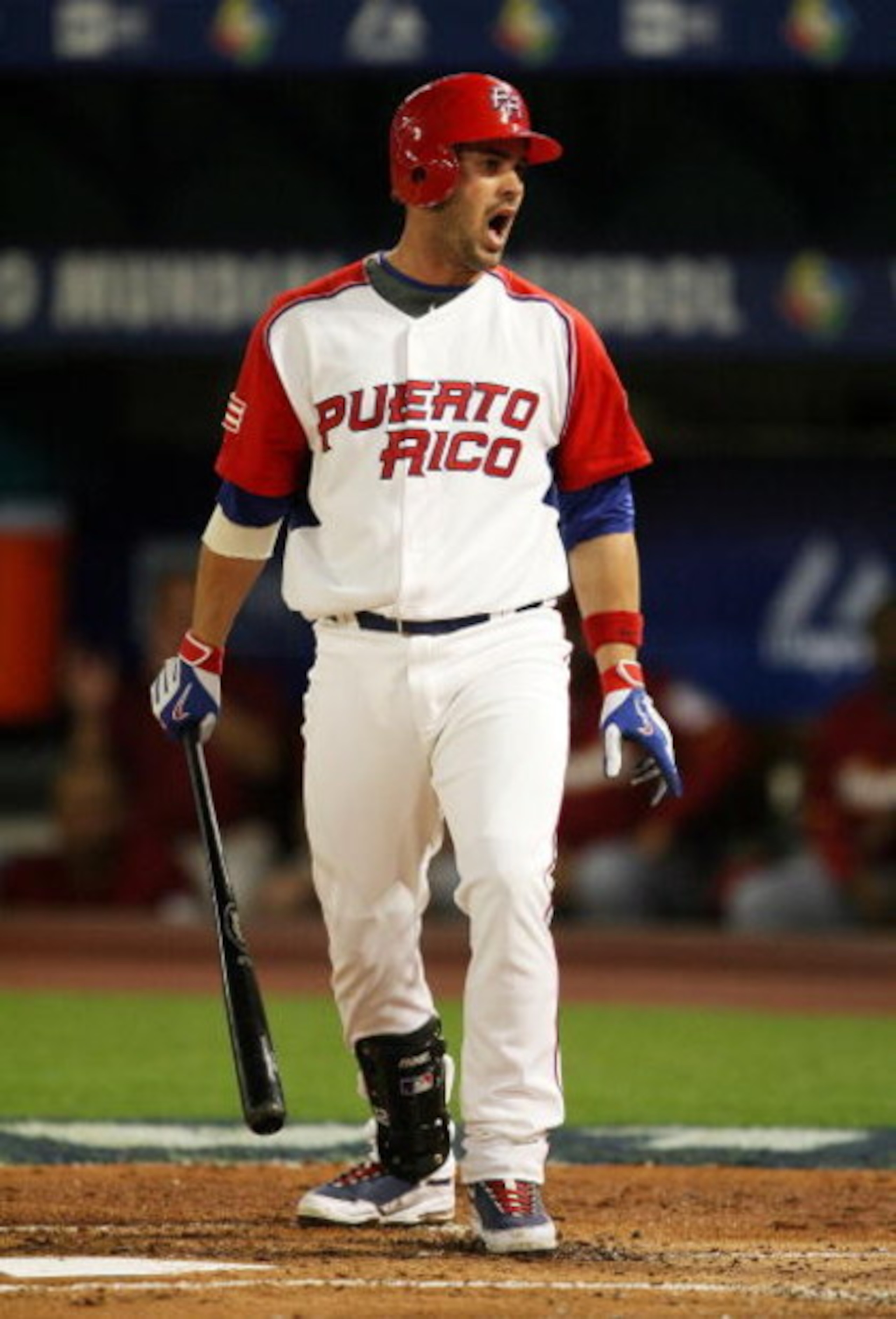 MIAMI - MARCH 16:  Ramon Vazquez #12 of Puerto Rico reacts to a called third strike in the first inning Venezuela during day 3 of round 2 of the World Baseball Classic at Dolphin Stadium on March 16, 2009 in Miami, Florida.  (Photo by Doug Benc/Getty Imag