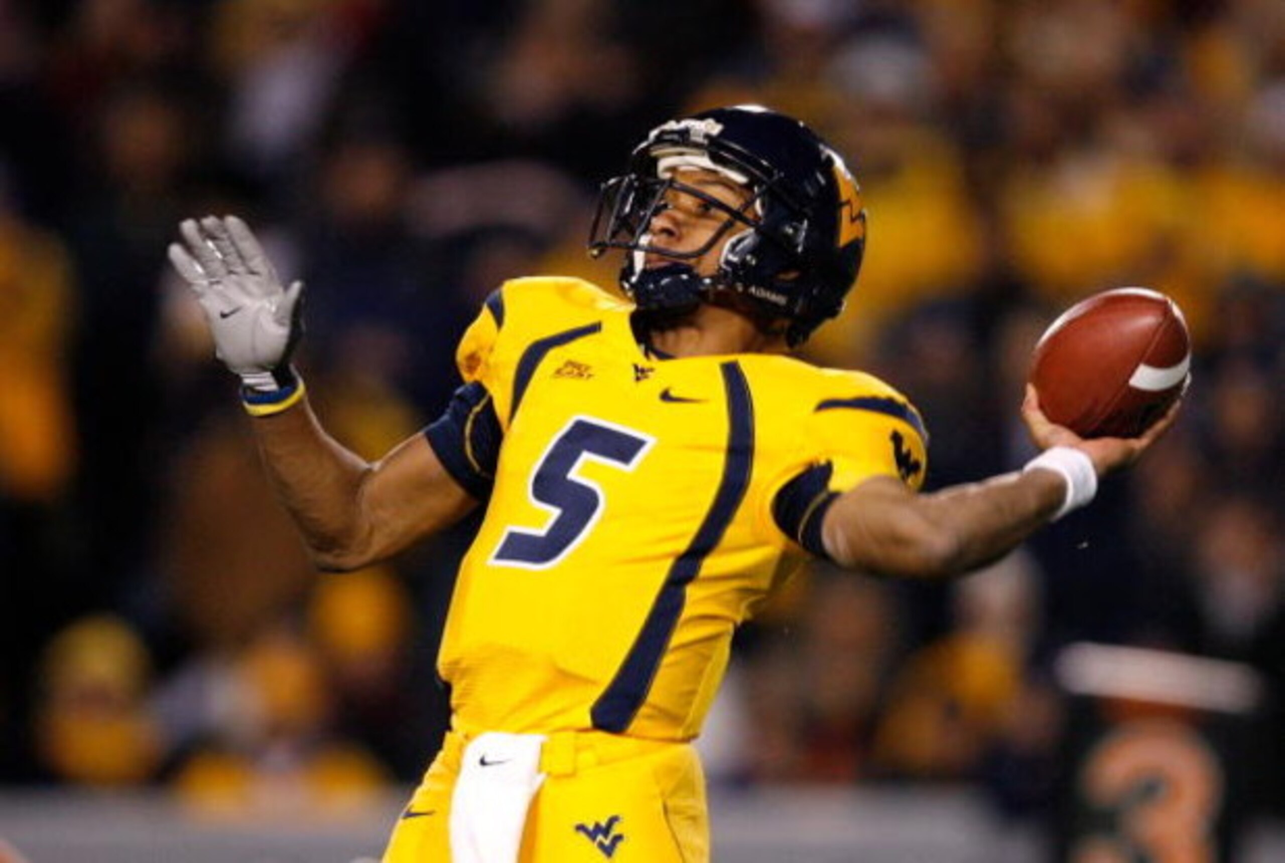 MORGANTOWN, WV - DECEMBER 1:  Quarterback Patrick White #5 of the West Virginia Mountaineers passes the ball before getting injured against the Pittsburgh Panthers during the first half at Milan Puskar Stadium December 1, 2007 in Morgantown, West Virginia