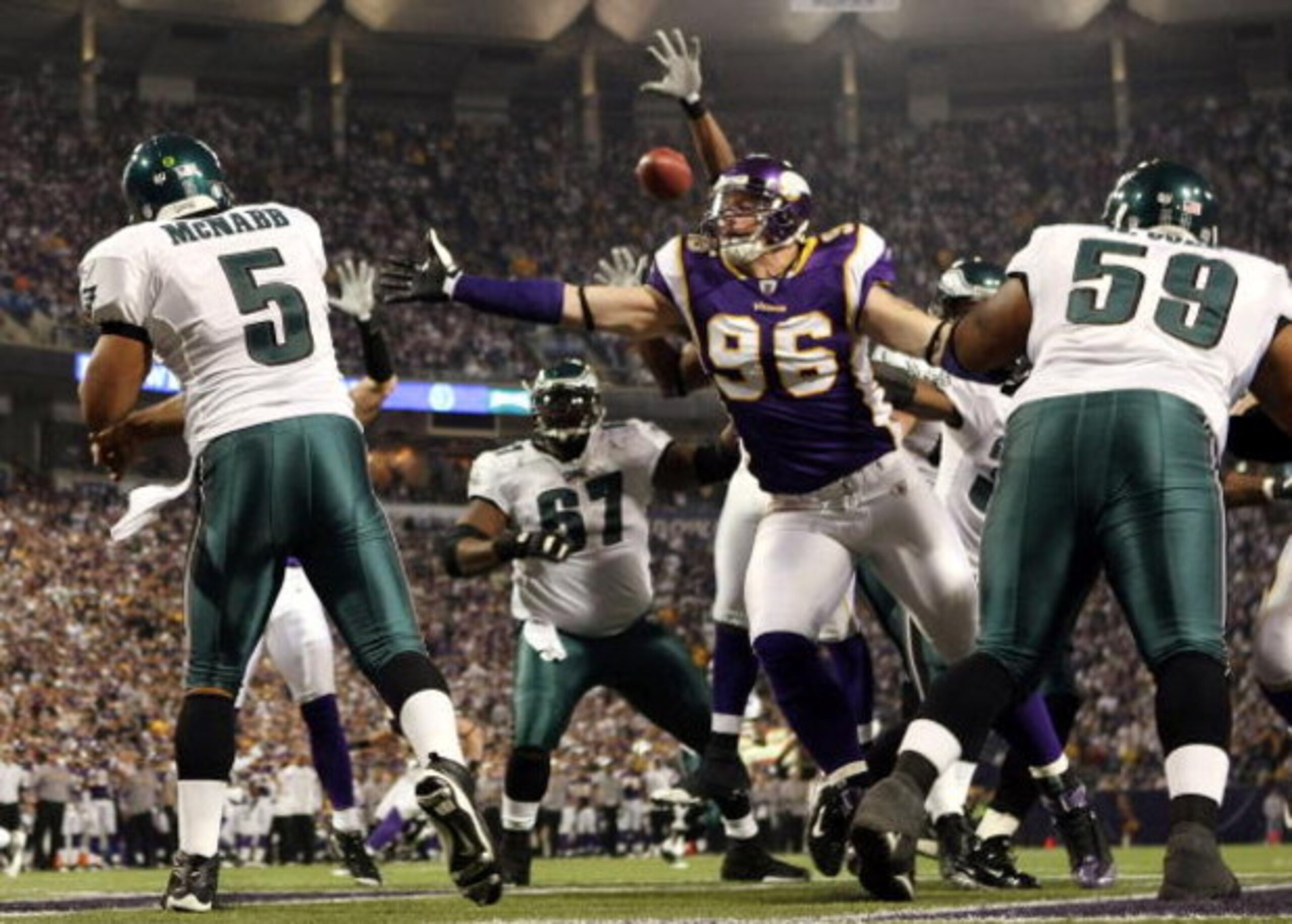 MINNEAPOLIS - JANUARY 04:   Donovan McNabb #5 of the Philadelphia Eagles passes the ball under pressure from Brian Robison #96 of the Minnesota Vikings during the NFC Wild Card playoff game on January 4, 2009 at the Hubert H. Humphrey Metrodome in Minneap