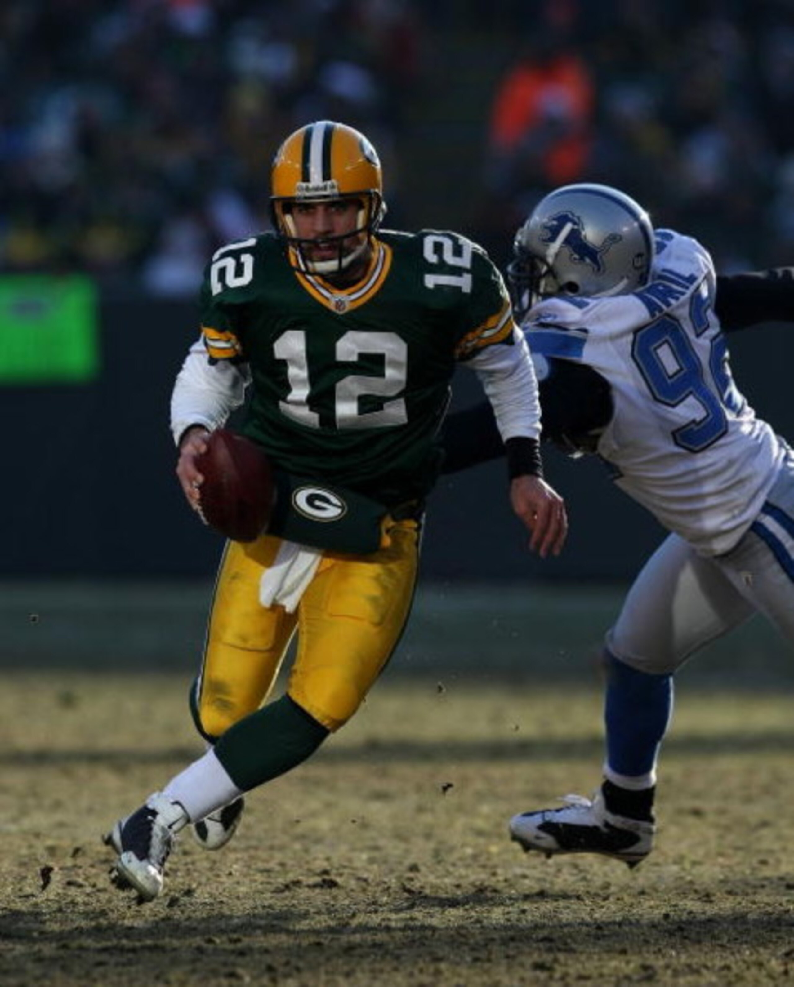 GREEN BAY, WI - DECEMBER 28: Aaron Rodgers #12 of the Green Bay Packers breaks away from Cliff Avril #92 of the Detroit Lions on December 28, 2008 at Lambeau Field in Green Bay, Wisconsin. The Packers defeated the Lions 31-21. (Photo by Jonathan Daniel/Ge