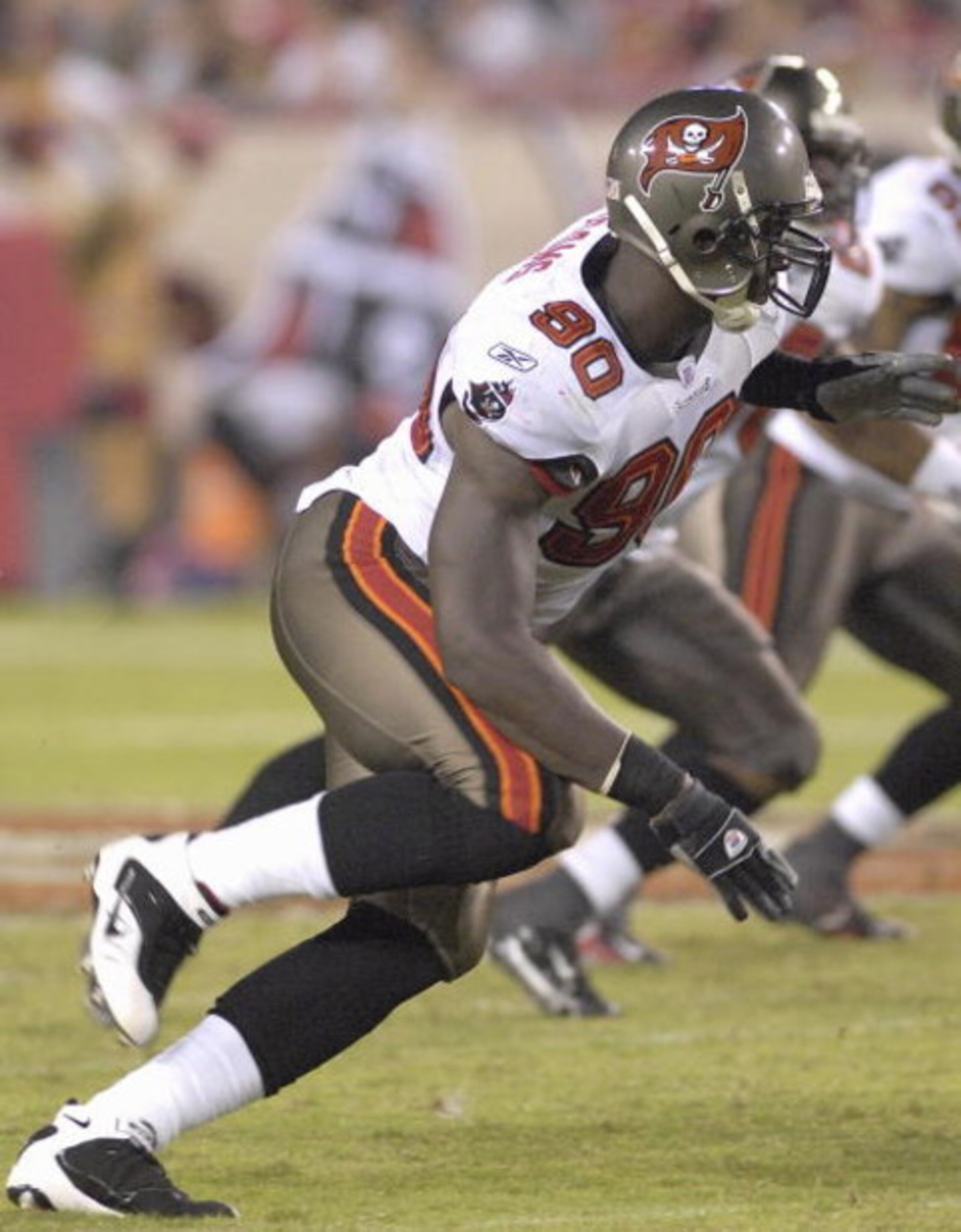 TAMPA, FL - AUGUST 10:  Defensive end Gaines Adams #90 of the Tampa Bay Buccaneers rushes the pocket against the New England Patriots at Raymond James Stadium on August 10, 2007 in Tampa, Florida. The Bucs won 13 - 10. (Photo by Al Messerschmidt/Getty Ima