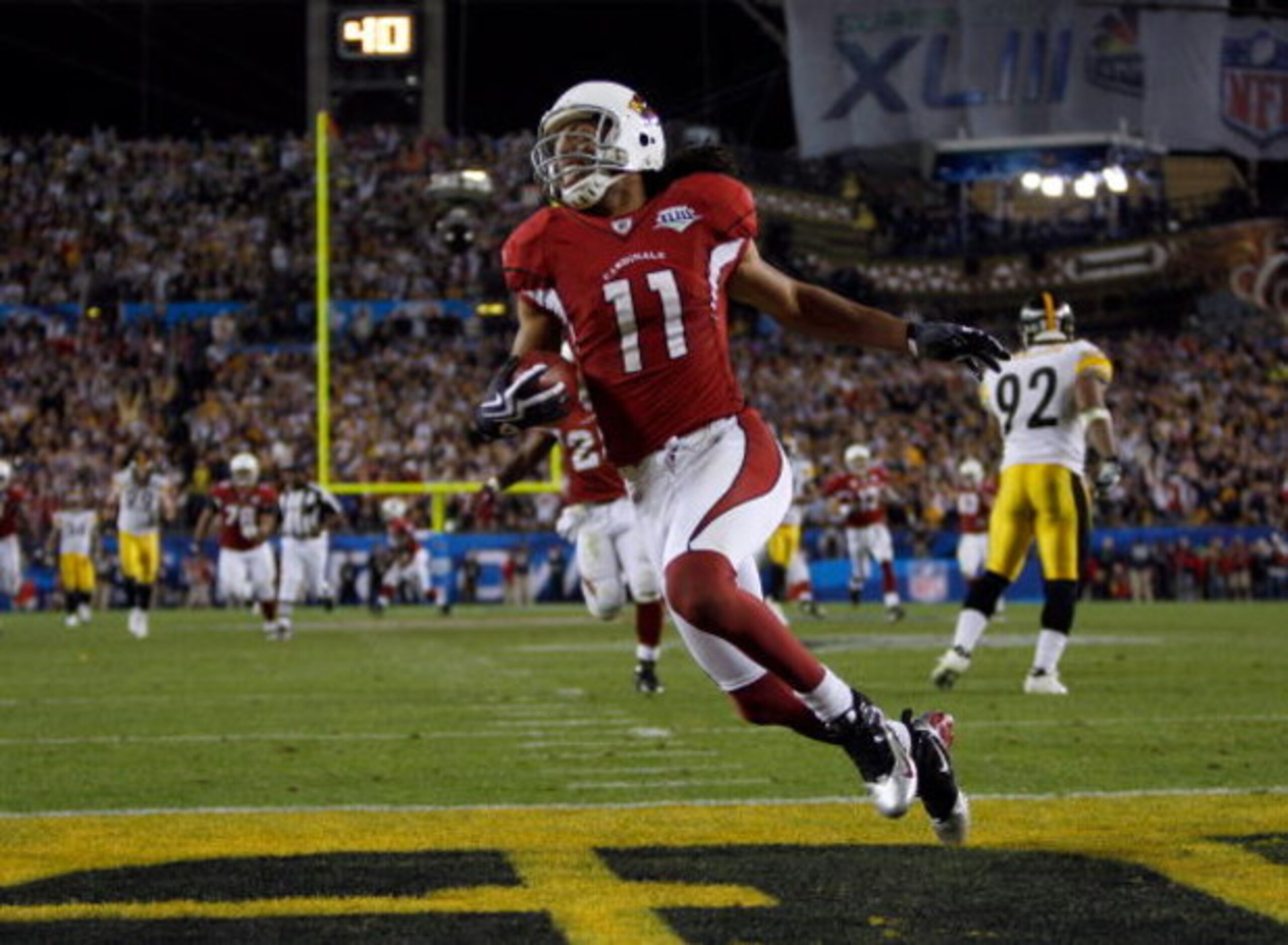 TAMPA, FL - FEBRUARY 01:  Larry Fitzgerald #11 of the Arizona Cardinals celebrates after scoring a touchdown in the fourth quarter against the Pittsburgh Steelers during Super Bowl XLIII on February 1, 2009 at Raymond James Stadium in Tampa, Florida.  (Ph