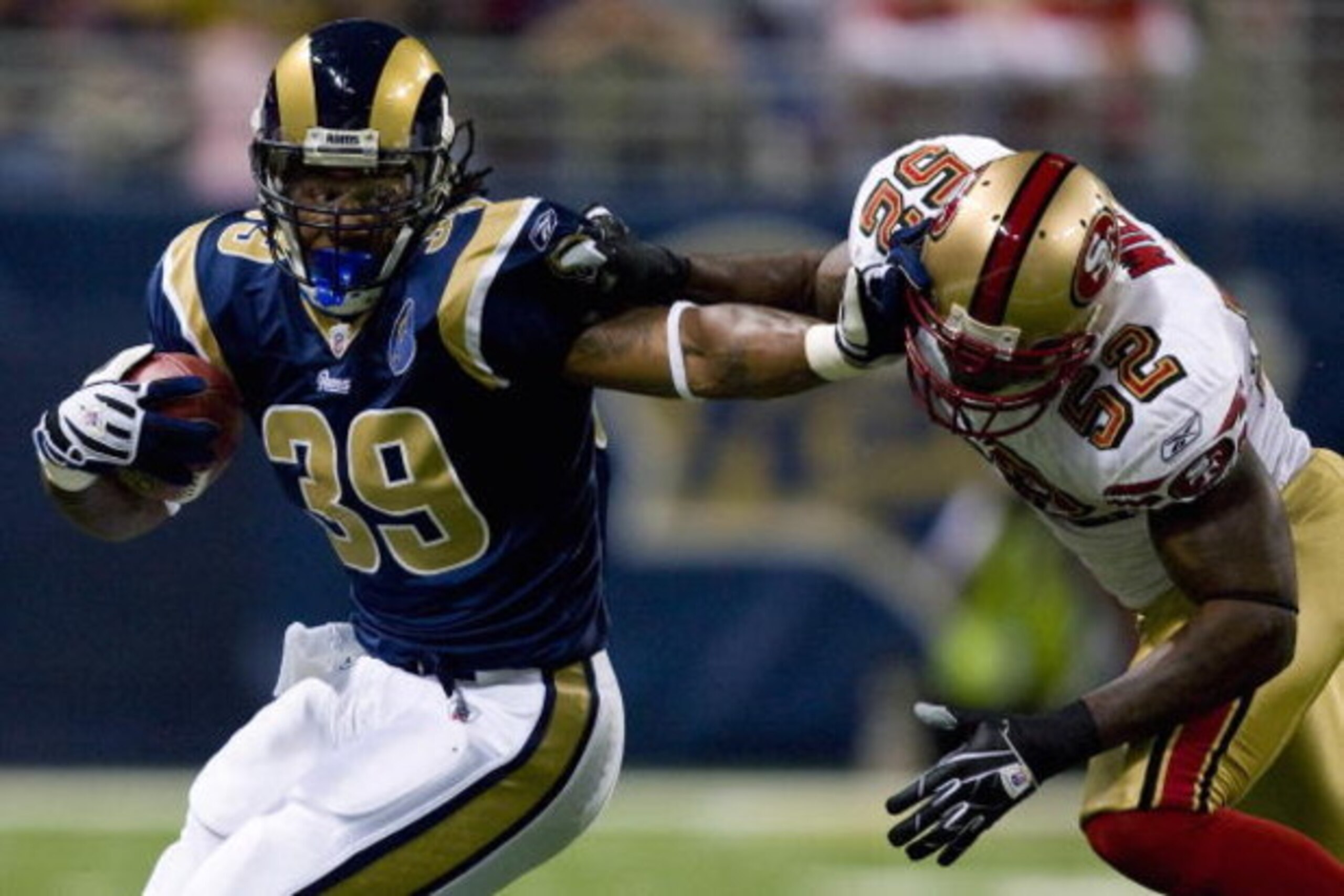 ST. LOUIS, MO - DECEMBER 21: Steven Jackson #39 of the St. Louis Rams looks to get past Patrick Willis #52 of the San Francisco 49ers at the Edward Jones Dome on December 21, 2008 in St. Louis, Missouri.  (Photo by Dilip Vishwanat/Getty Images)