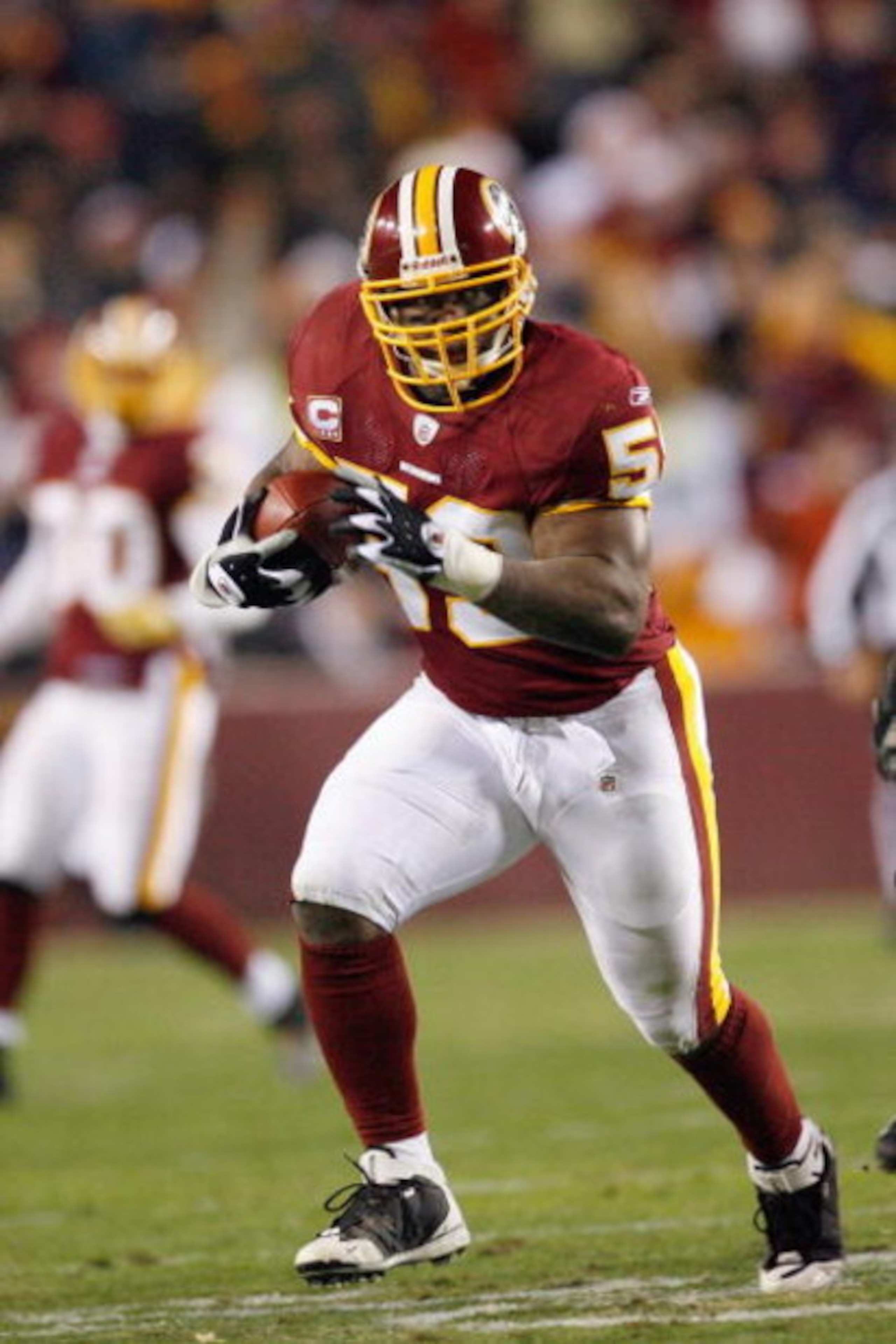 LANDOVER, MD - DECEMBER 21:  Marcus Washington #53 of the Washington Redskins carries the ball during the game of the Philadelphia Eagles on December 21, 2008 at FedEx Field in Landover, Maryland.  (Photo by Kevin C. Cox/Getty Images)