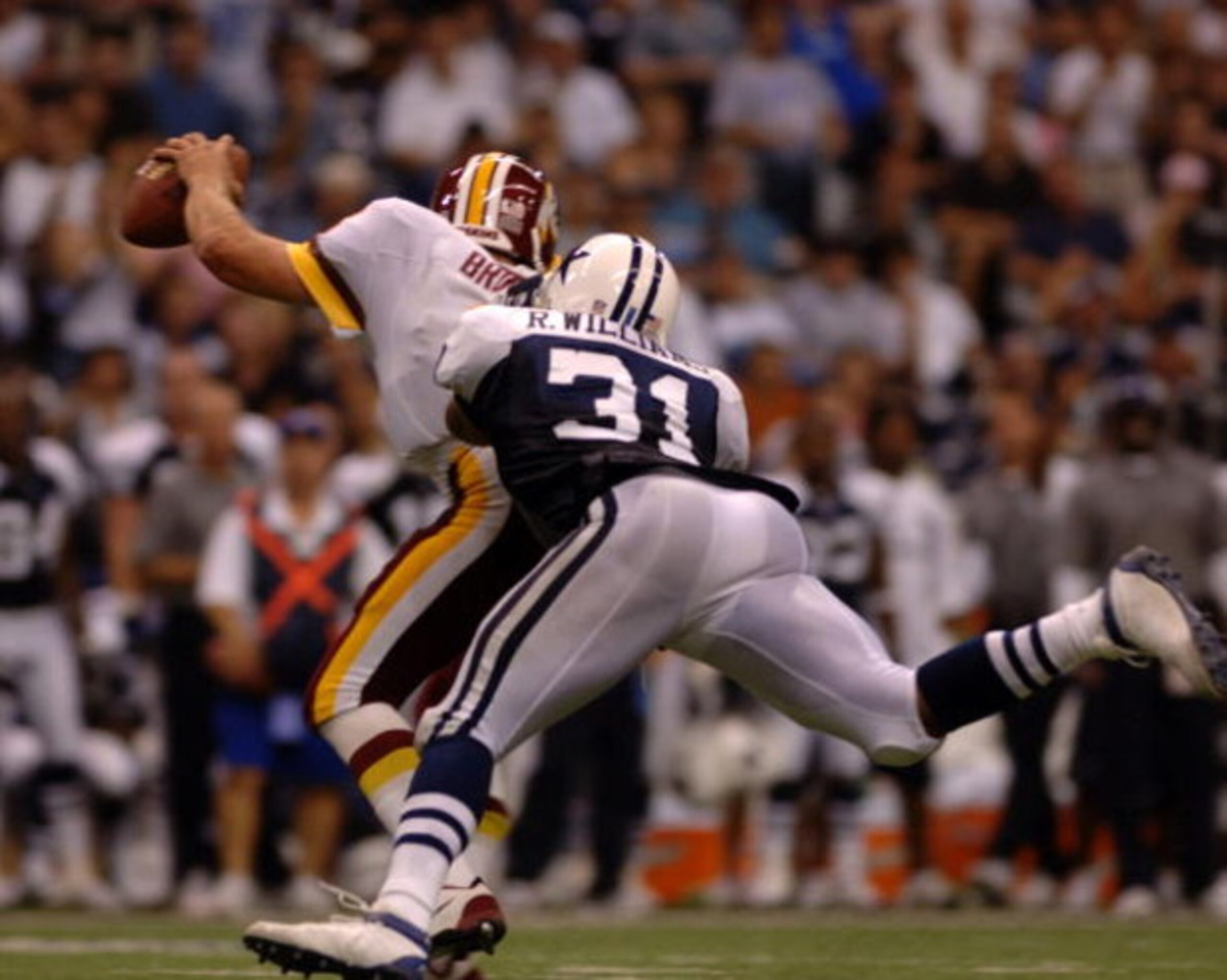 Washington Redskins  quarterback Mark Brunell scrambles from the pass rush  by  Dallas Cowboys safety Roy Williams  during a Monday Night Football game September 19, 2005 in Irving, Texas.  The Skins defeated the Cowboys 14 - 13.  (Photo by Al Messerschmi