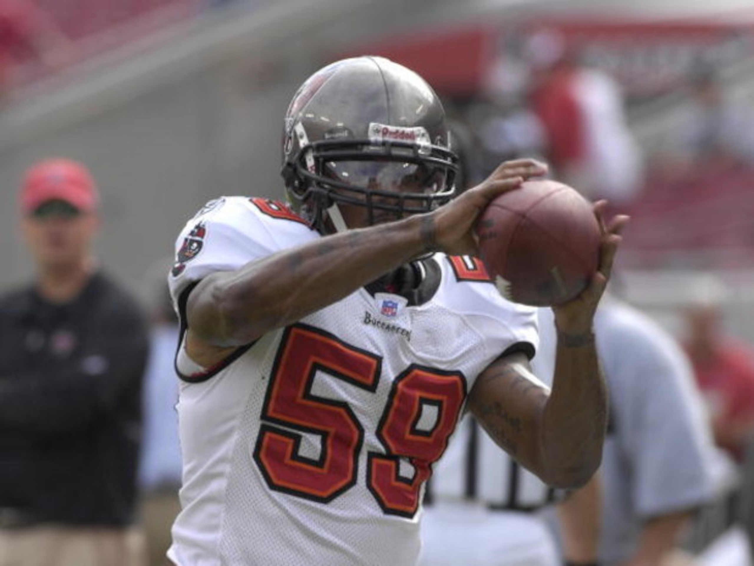 TAMPA, FL - OCTOBER 28:  Linebacker Cato June #59 of the Tampa Bay Buccaneers warms up for play against the Jacksonville Jaguars at Raymond James Stadium on October 28, 2007 in Tampa, Florida.  The Jaguars won 24 - 23. (Photo by Al Messerschmidt/Getty Ima