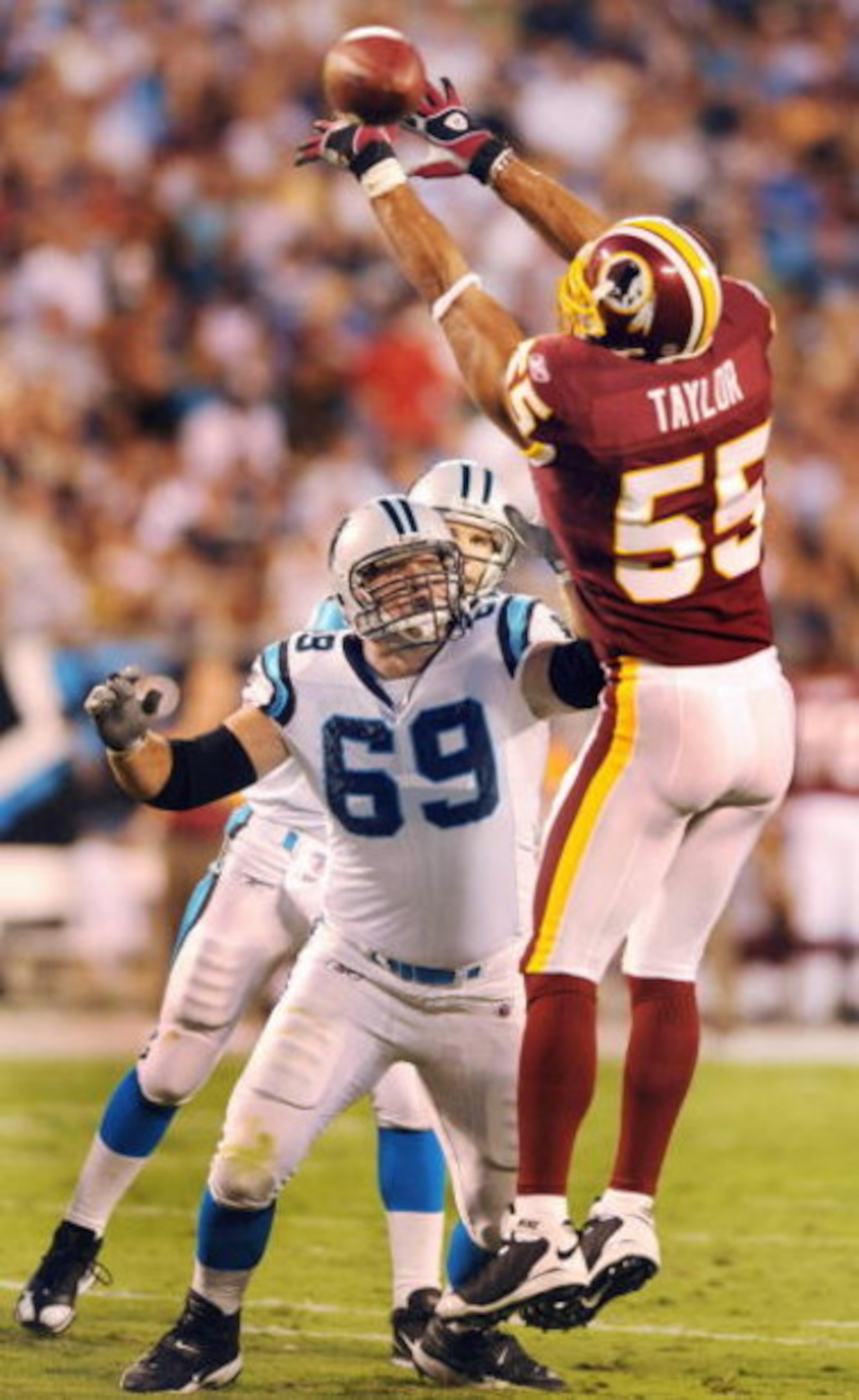 CHARLOTTE, NC - AUGUST 23   Offensive tackle Jordan Gross #69 of the Carolina Panthers tries to block defensive end Jason Taylor #55 of the Washington Redskins during the NFL preseason game at Bank of America Stadium on August, 23, 2008 in Charlotte, Nort