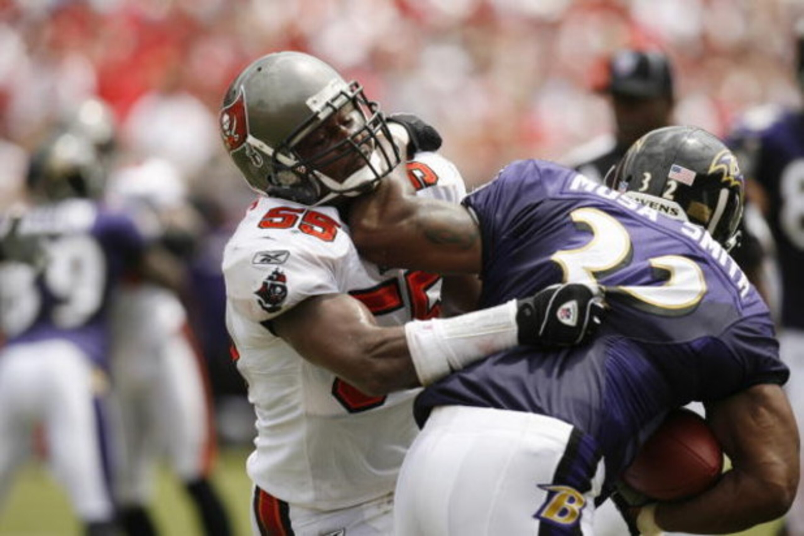 TAMPA, FL - SEPTEMBER 10:  Linebacker Derrick Brooks #55 of the Tampa Bay Buccaneers tries to stop running back Musa Smith #32 of the Baltimore Ravens during their NFL game on September 10, 2006 at Raymond James Stadium in Tampa, Florida. (Photo by Matt S