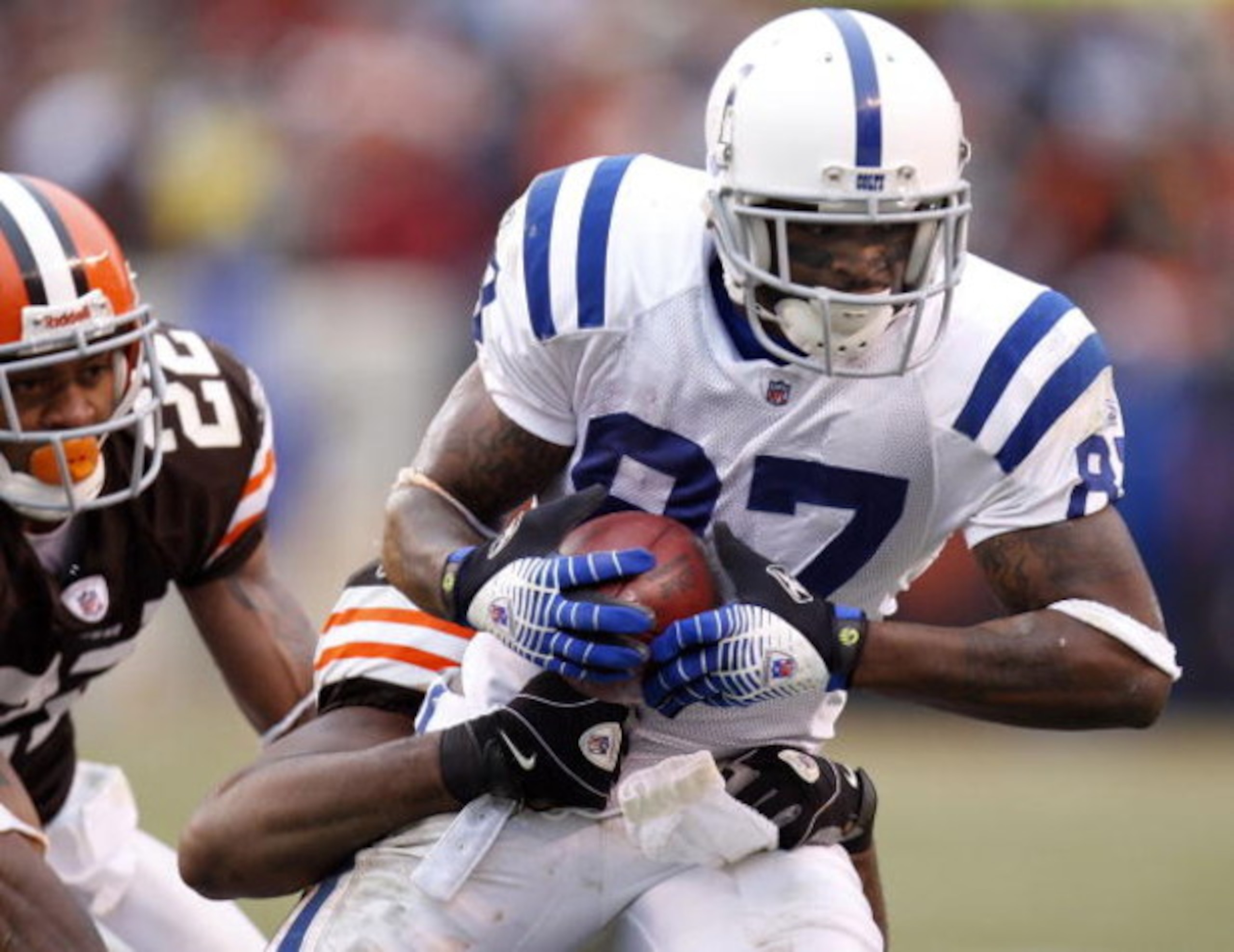 CLEVELAND - NOVEMBER 30:  Reggie Wayne #87 of the Indianapolis Colts is tackled after a third quarter catch by Sean Jones #26 and Brandon McDonald #22 of the Cleveland Browns during a fourth quarter run on November 30, 2008 at Cleveland Browns Stadium in 