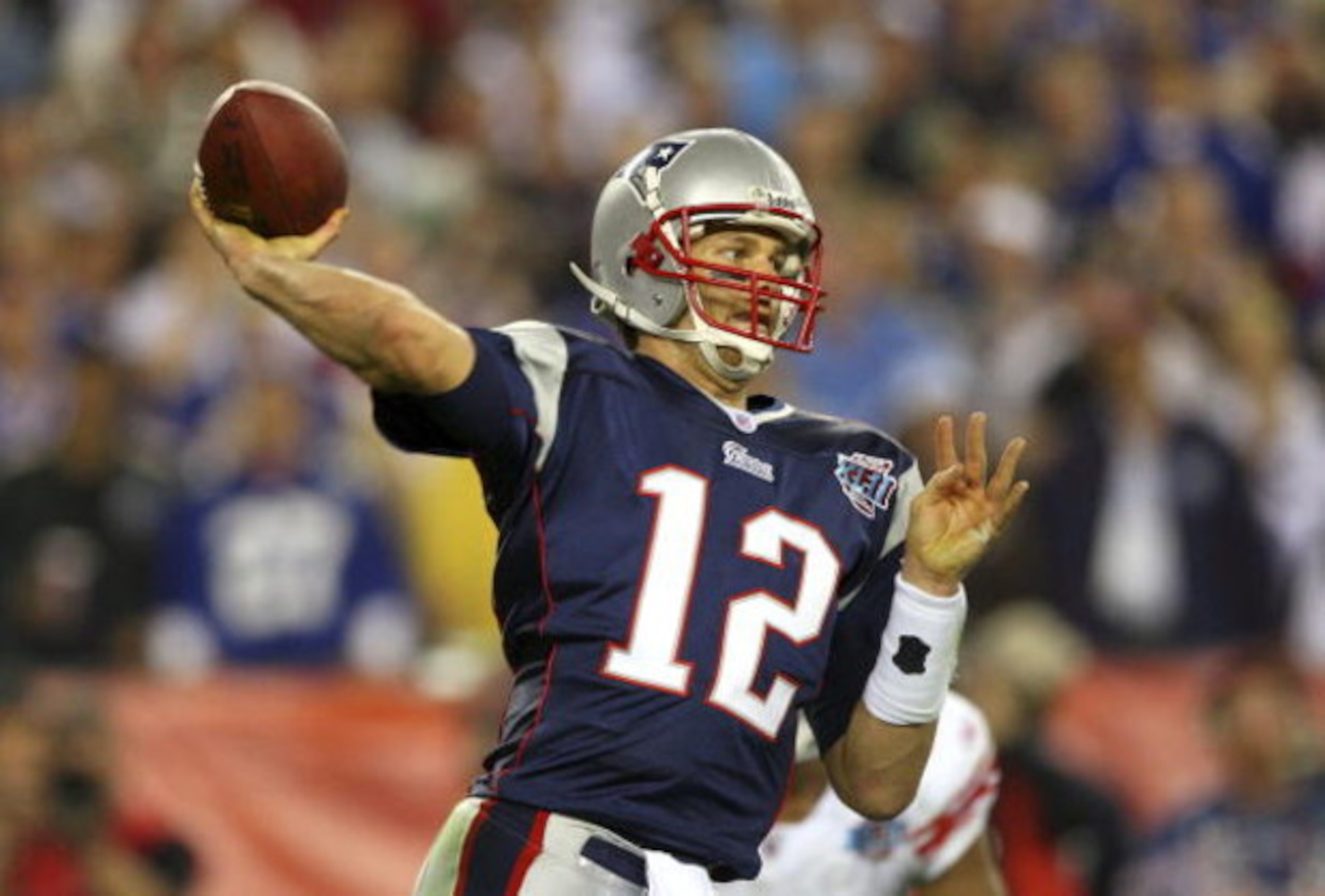 GLENDALE, AZ - FEBRUARY 03:  Quarterback Tom Brady #12 of the New England Patriots drops back to pass against the New York Giants the second half of Super Bowl XLII on February 3, 2008 at the University of Phoenix Stadium in Glendale, Arizona. The Giants 