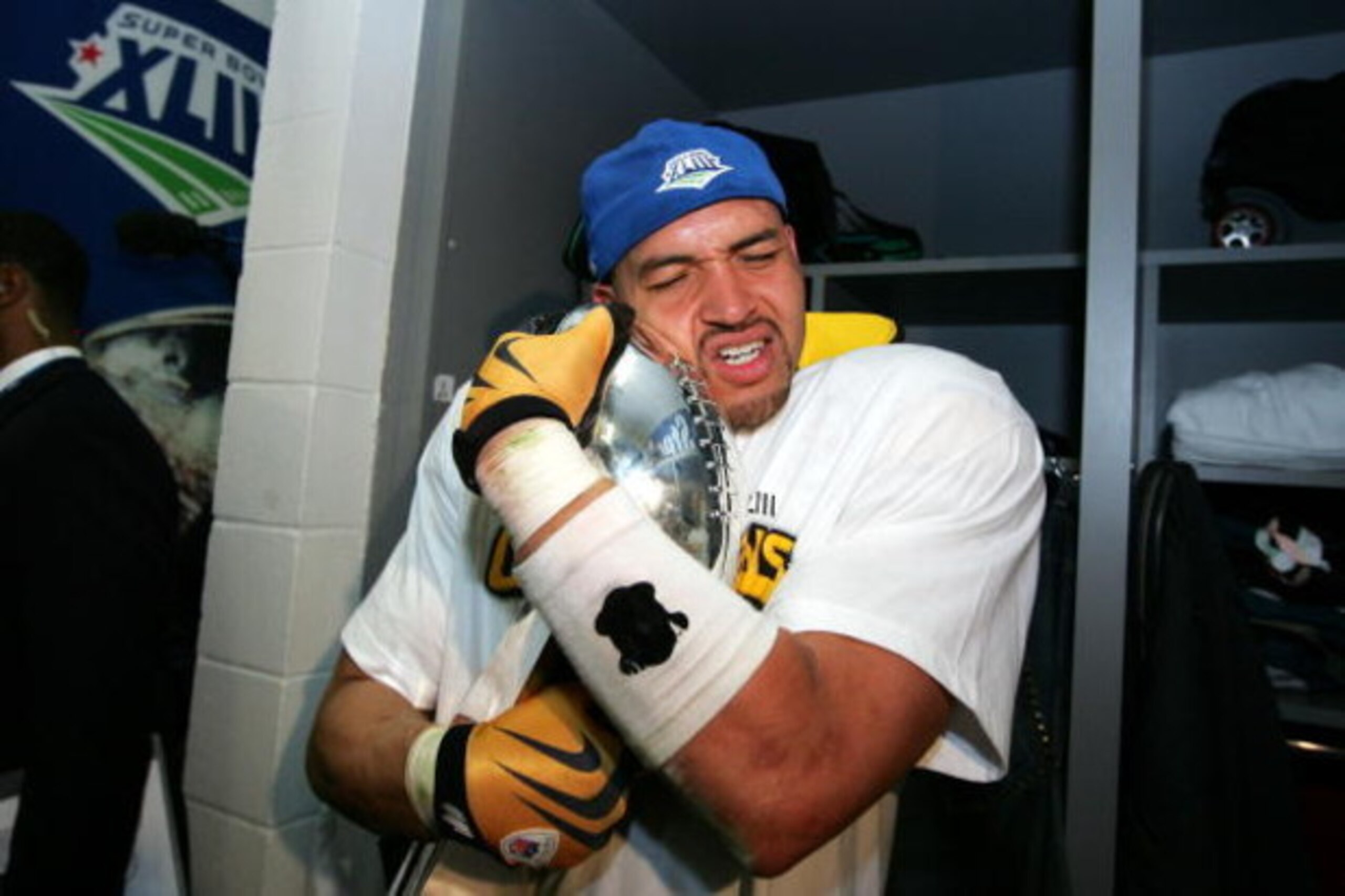 TAMPA, FL - FEBRUARY 01:  James Farrior #51 of the Pittsburgh Steelers hugs the Vince Lombardi trophy in the locker room after the Steelers won 27-23 against the Arizona Cardinals during Super Bowl XLIII on February 1, 2009 at Raymond James Stadium in Tam