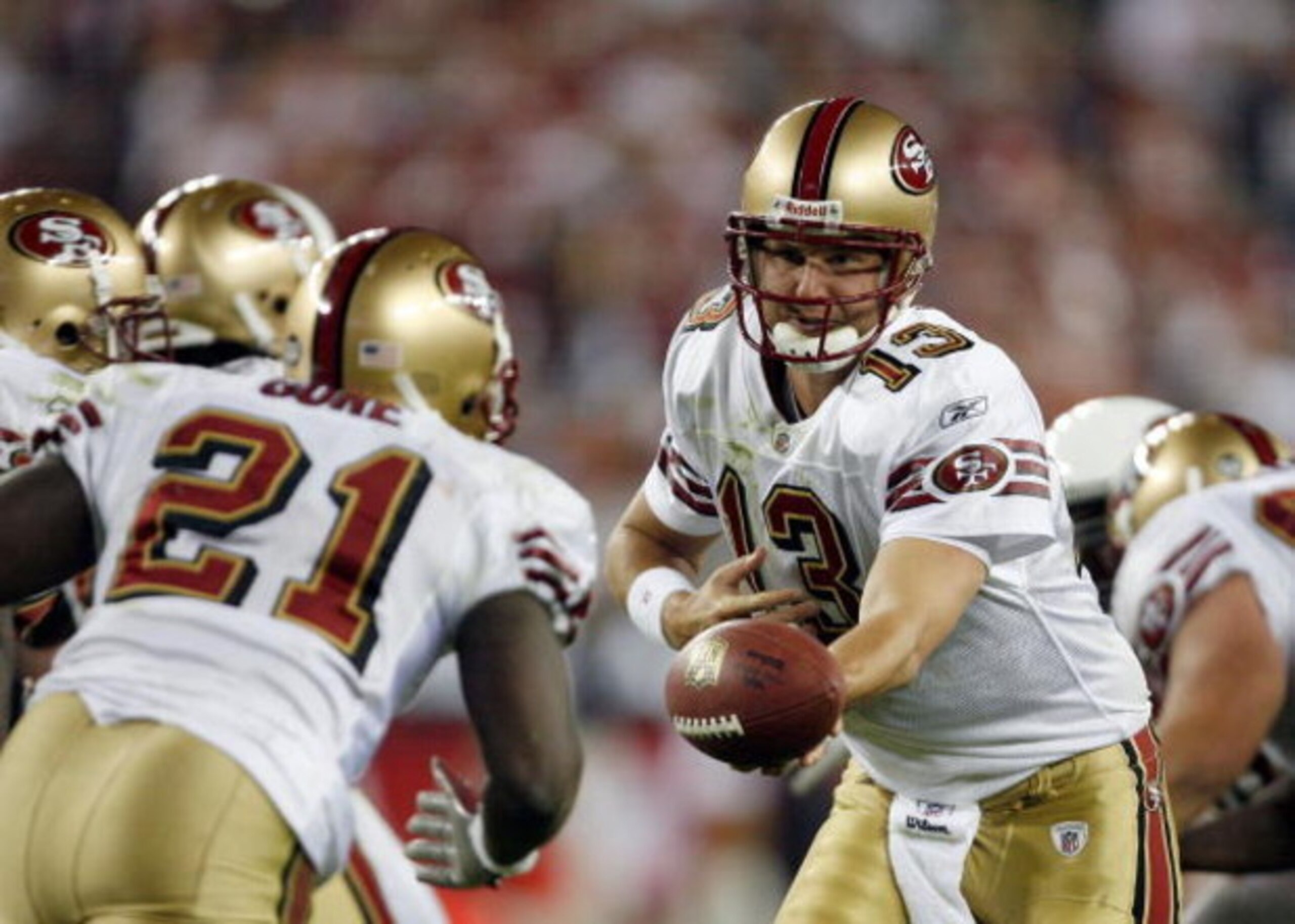 GLENDALE, AZ - NOVEMBER 10:  Quarterback Shaun Hill #13 of the San Francisco 49ers prepares to hand off to Frank Gore #21 against the Arizona Cardinals during the game at University of Phoenix Stadium on November, 10 2008 in Glendale, Arizona.  The Cardin
