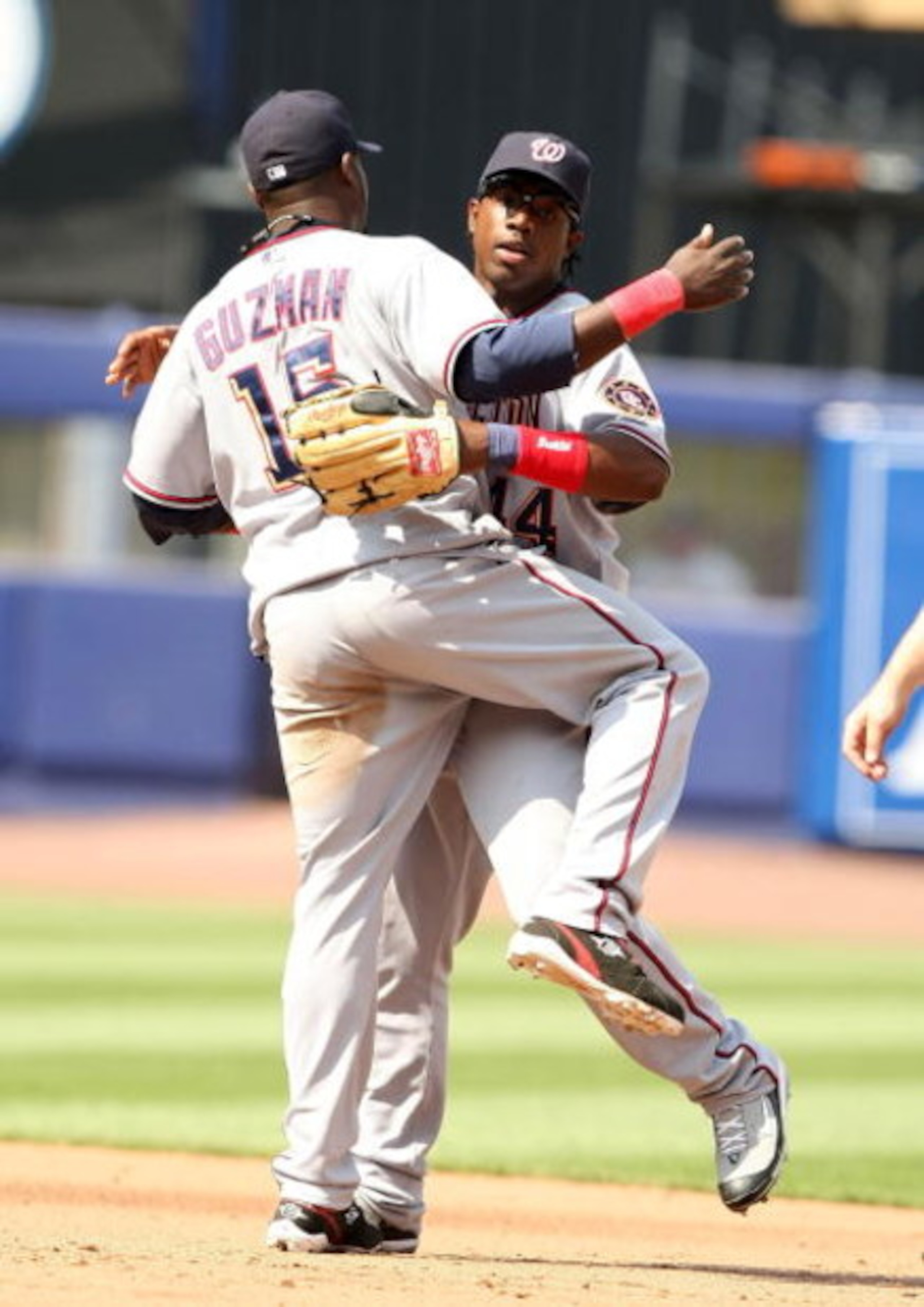 NEW YORK - MAY 15:  Lastings Milledge #44 and Cristan Guzman #15 of the Washington Nationals celebrate a win against the New York Mets on May 15, 2008 at Shea Stadium in the Flushing neighborhood of the Queens borough of New York City. The Nationals defea