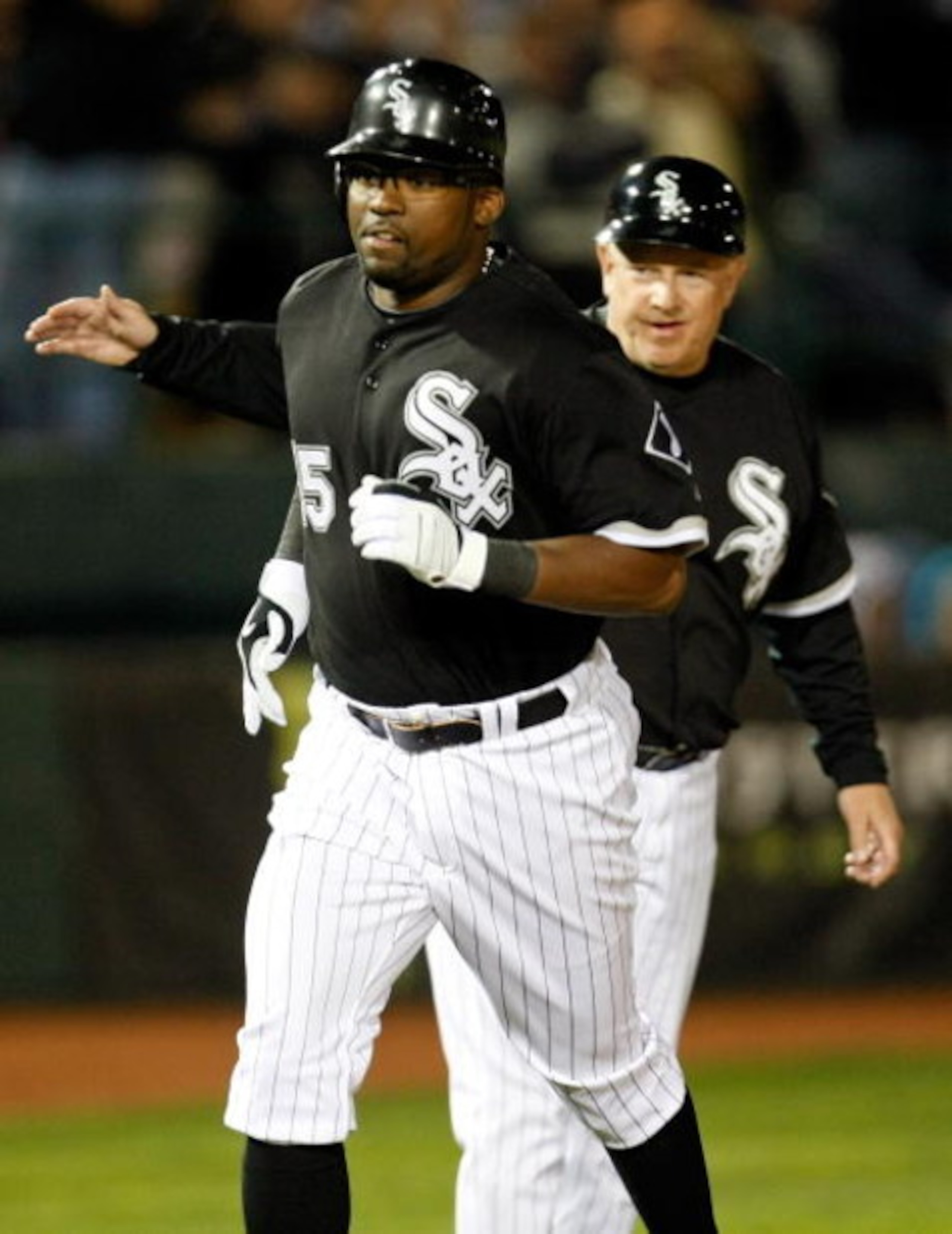 LAS VEGAS - MARCH 04:  Wilson Betemit #15 of the Chicago White Sox is congratulated by third base coach Jeff Cox #8 after Betemit hit a two-run home run against the Chicago Cubs during an exhibition game at Cashman Field March 4, 2009 in Las Vegas, Nevada