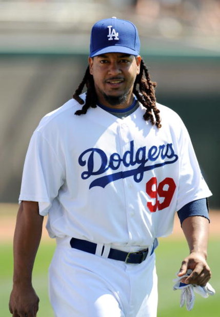 GLENDALE, AZ - MARCH 13:   Manny Ramirez #99 of the Los Angeles Dodgers walks along the field before a Spring Training game against the Texas Rangers on March 13, 2009 at Camelback Ranch in Glendale, Arizona.  (Photo by Lisa Blumenfeld/Getty Images)
