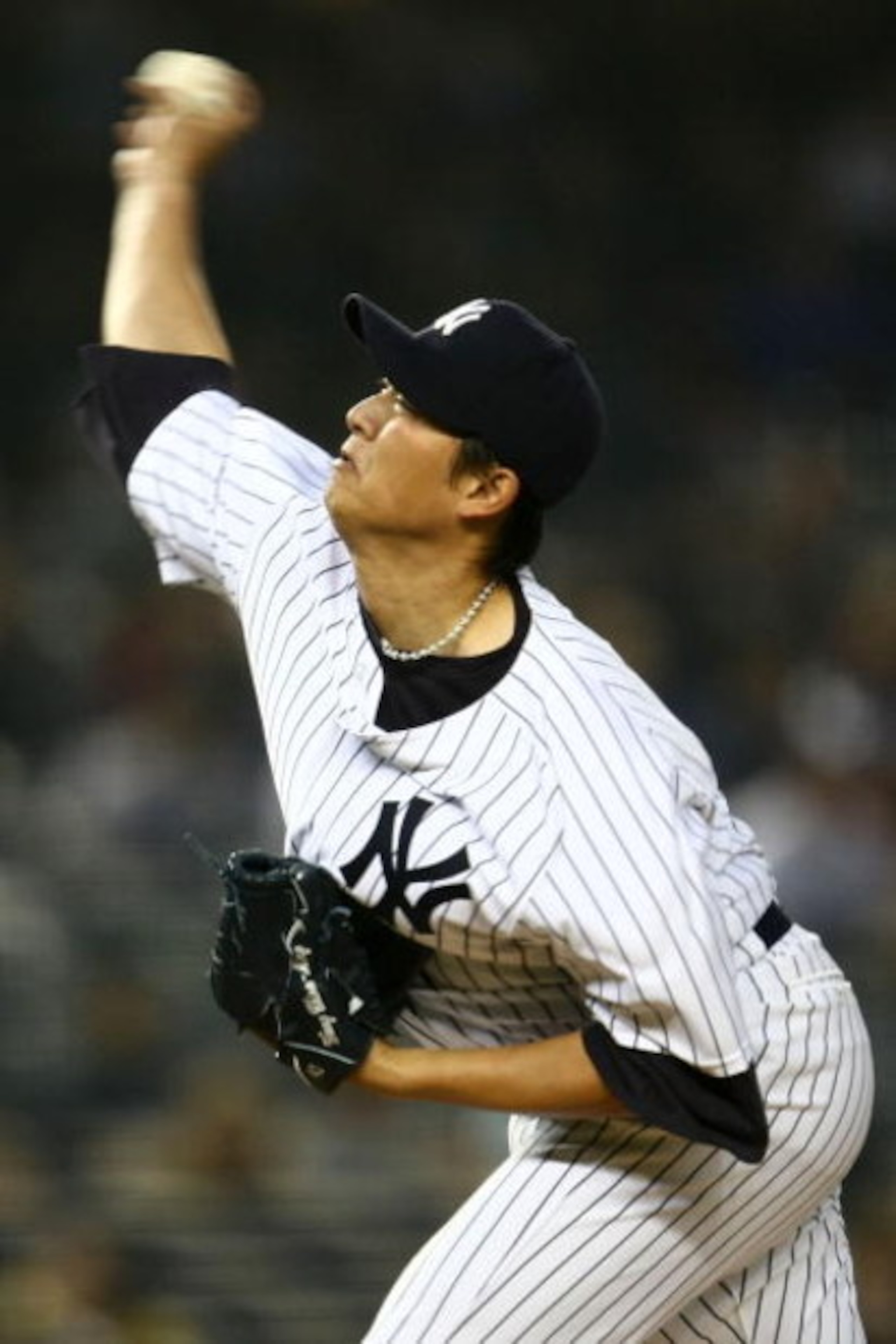 NEW YORK - APRIL 03:  Chien-Ming Wang #40 of the New York Yankees pitches against the Chicago Cubs during their game on April 3, 2009 at Yankee Stadium in the Bronx borough of New York City. The exhibition game is the first game to be played at the new Ya