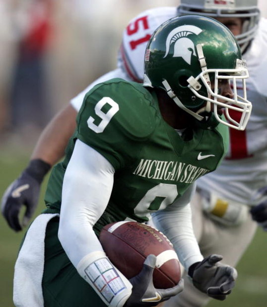EAST LANSING, MI - OCTOBER 14:  Demond Williams #9 of the Michigan State Spartans tries to get around the tackle of Ross Homan #51 of the Ohio State Buckeys during second quarter action on October 14, 2006 at Spartan Stadium in East Lansing, Michigan. Ohi