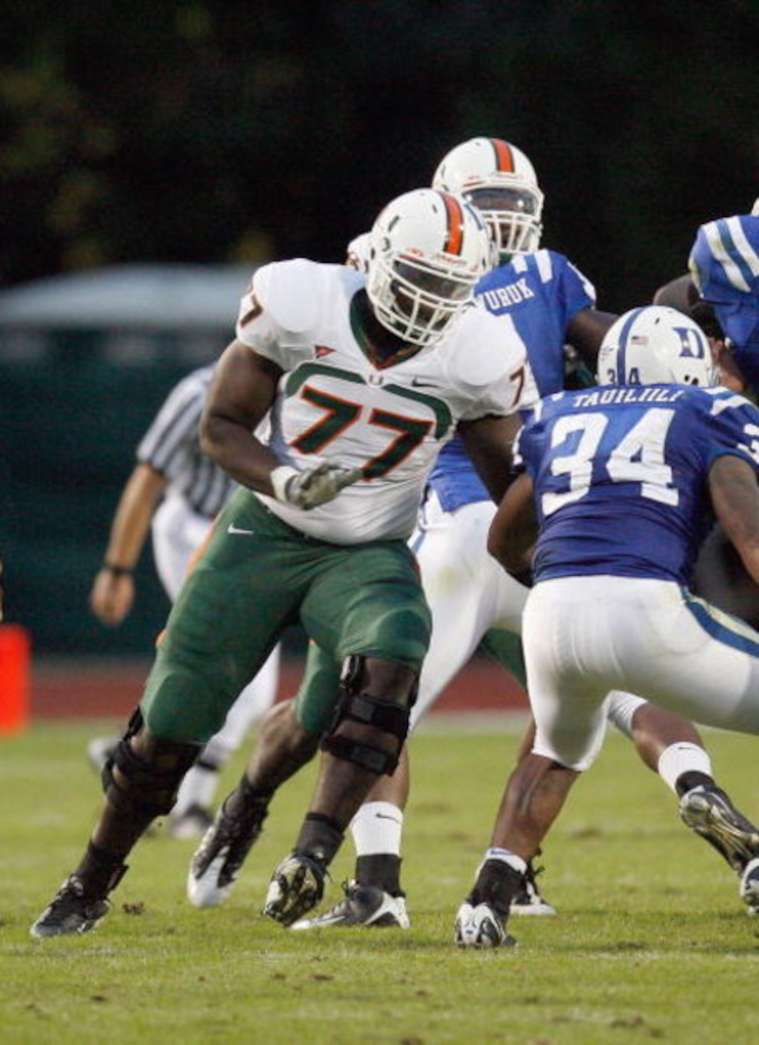 DURHAM, NC - OCTOBER 18:  Reggie Youngblood #77 of the Miami Hurricanes moves to tackle Michael Tauiliili #34 of the Duke Blue Devils # during the game at Wallace Wade Stadium on October 18, 2008 in Durham, North Carolina.  (Photo by Kevin C. Cox/Getty Im