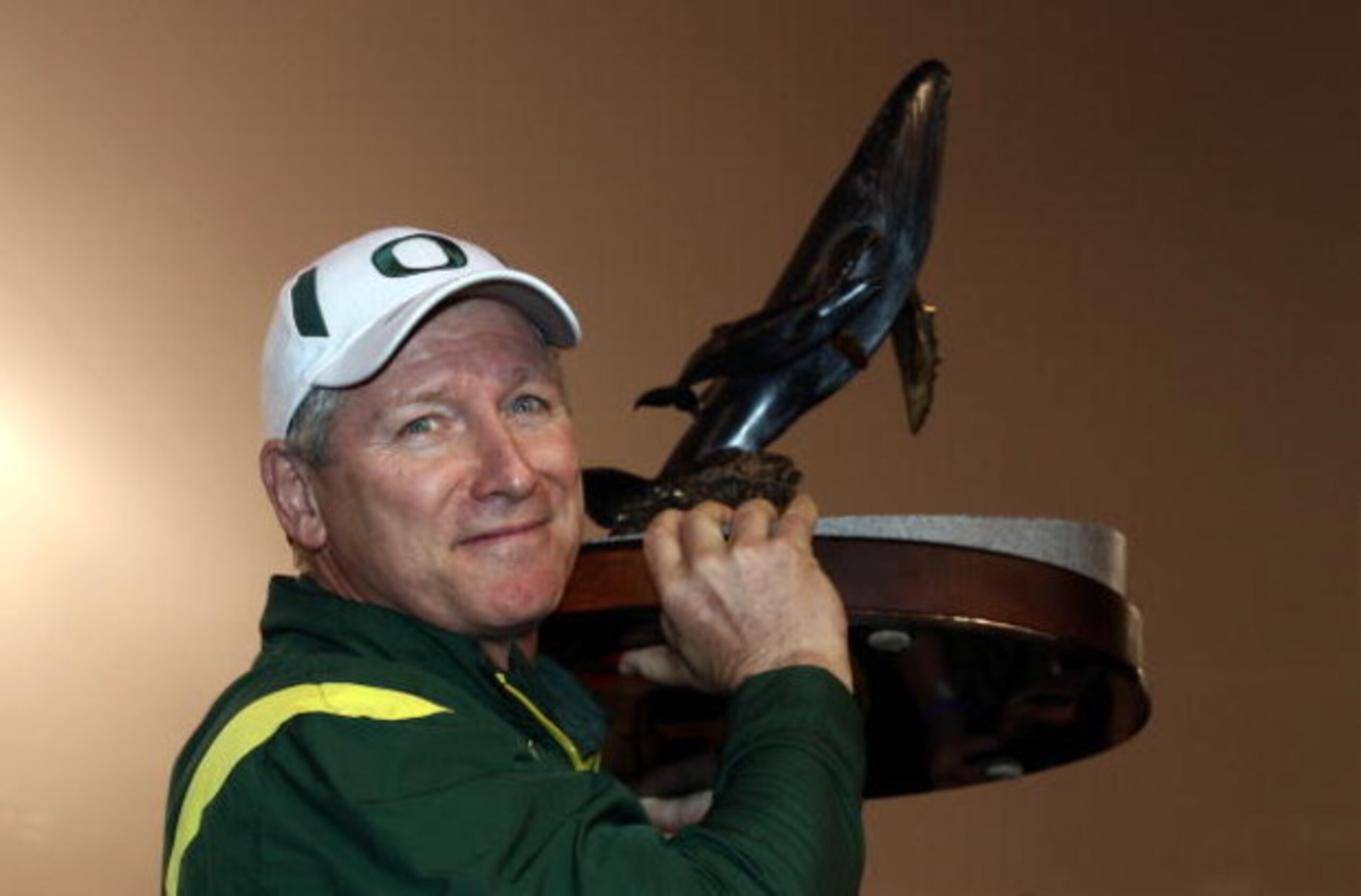 SAN DIEGO, CA - DECEMBER 30:   Head Coach Mike Bellotti of the University of Oregon Ducks holds the winner's trophy after beating the Oklahoma State University Cowboys in the Pacific Life Holiday Bowl at Qualcomm Stadium on December 30, 2008 in San Diego,