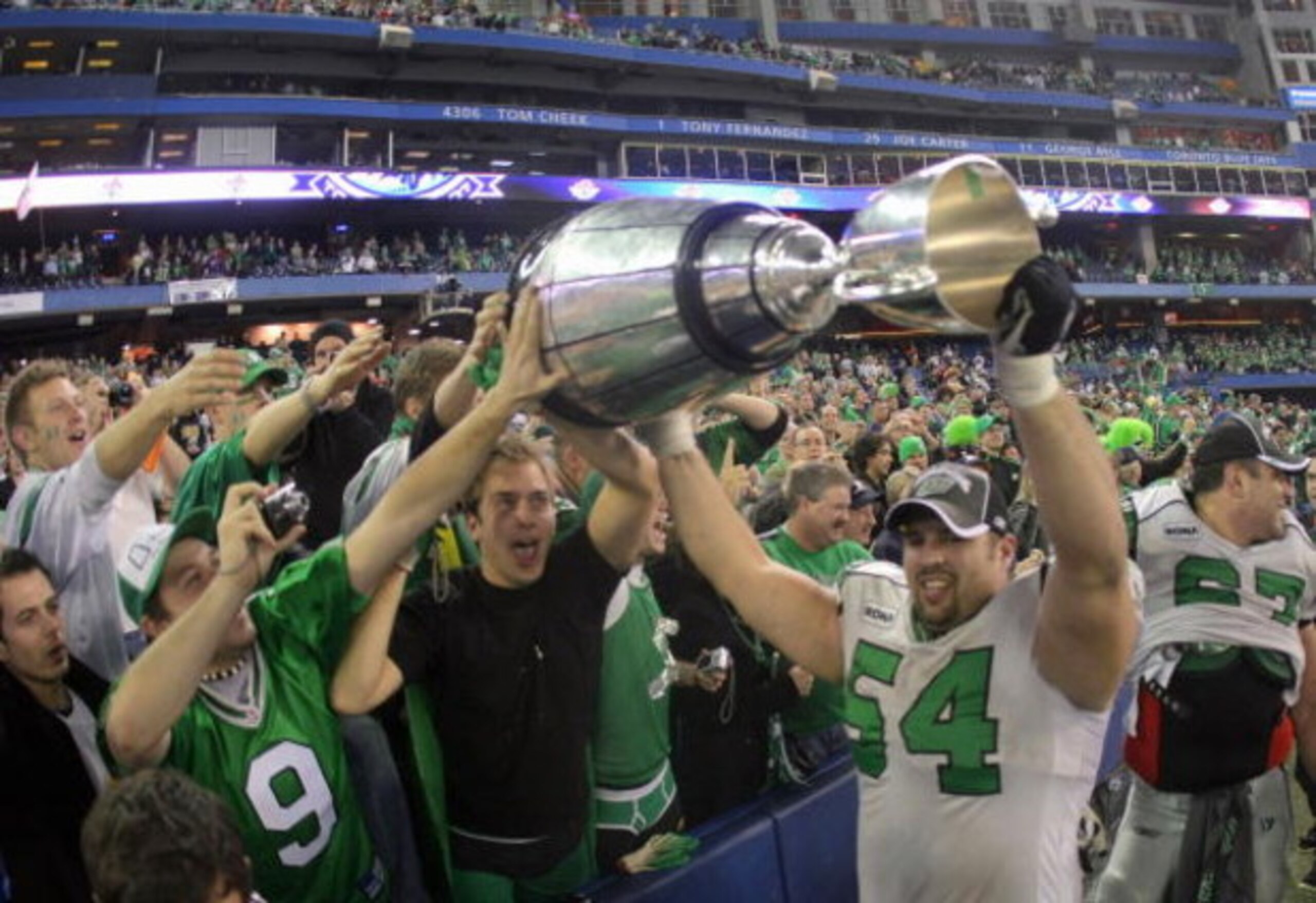 TORONTO - NOVEMBER 25:  Jeremy O'Day #54 of the Saskatchewan Rough Riders hoists the Grey Cup with fans in celebration of a 23-19 victory over the Winnipeg Blue Bombers during the 95th Grey Cup on November 25, 2007 at the Rogers Centre in Toronto, Ontario