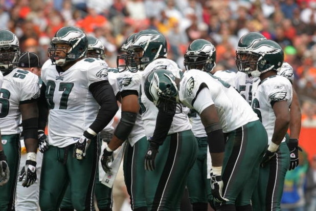 CLEVELAND - OCTOBER 24:  The Philadelphia Eagles defensive unit talks with head coach Andy Reid during the game with the Cleveland Browns on October 24, 2004 at Cleveland Browns Stadium in Cleveland, Ohio. The Eagles defeated the Browns 34-31 in overtime.