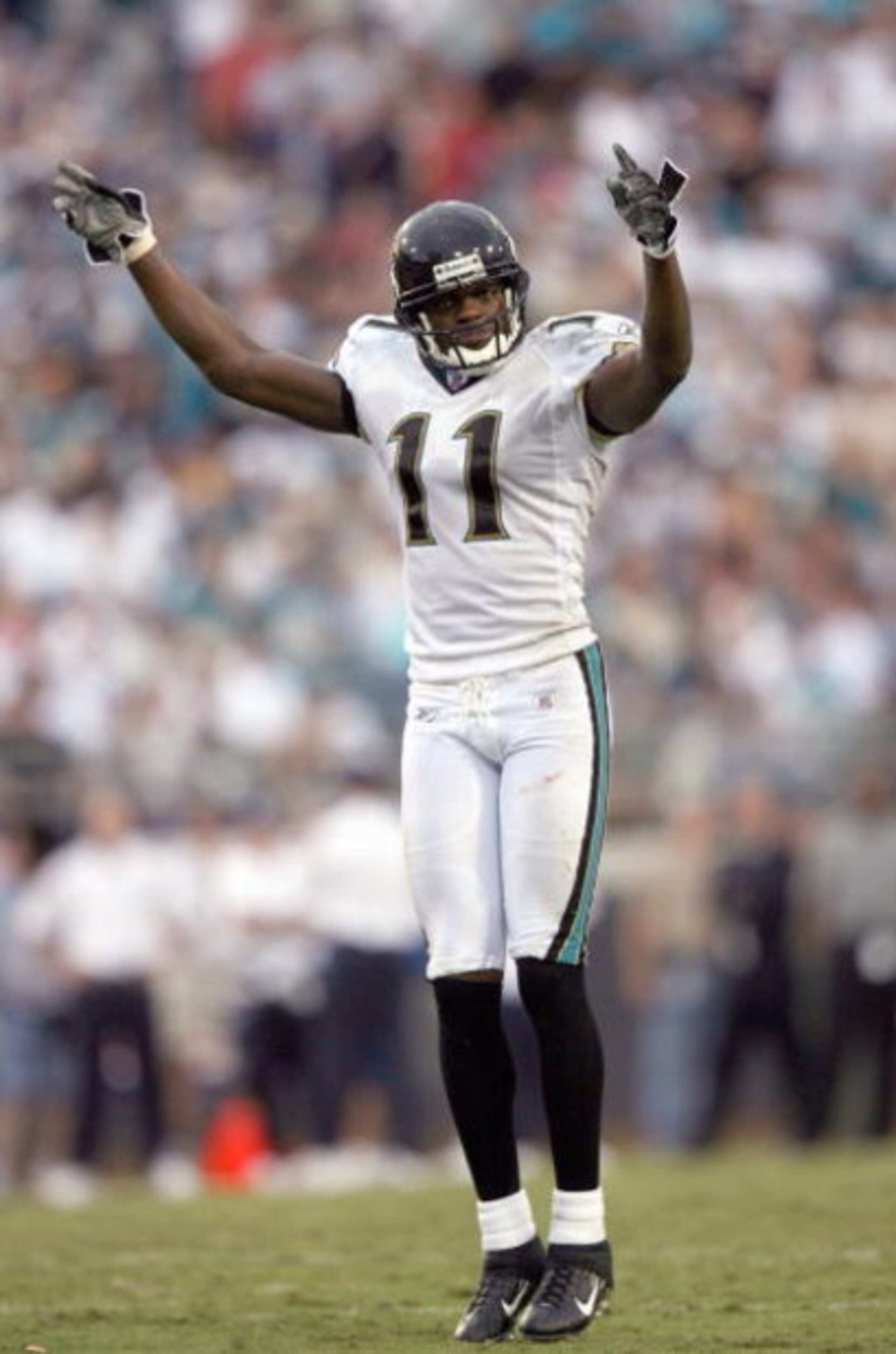JACKSONVILLE, FL - SEPTEMBER 10:  Reggie Williams #11 of the Jacksonville Jaguars celebrates on the field during the game against the Dallas Cowboys at Alltel Stadium on September 10, 2006 in Jacksonville, Florida. (Photo by Doug Benc/Getty Images)