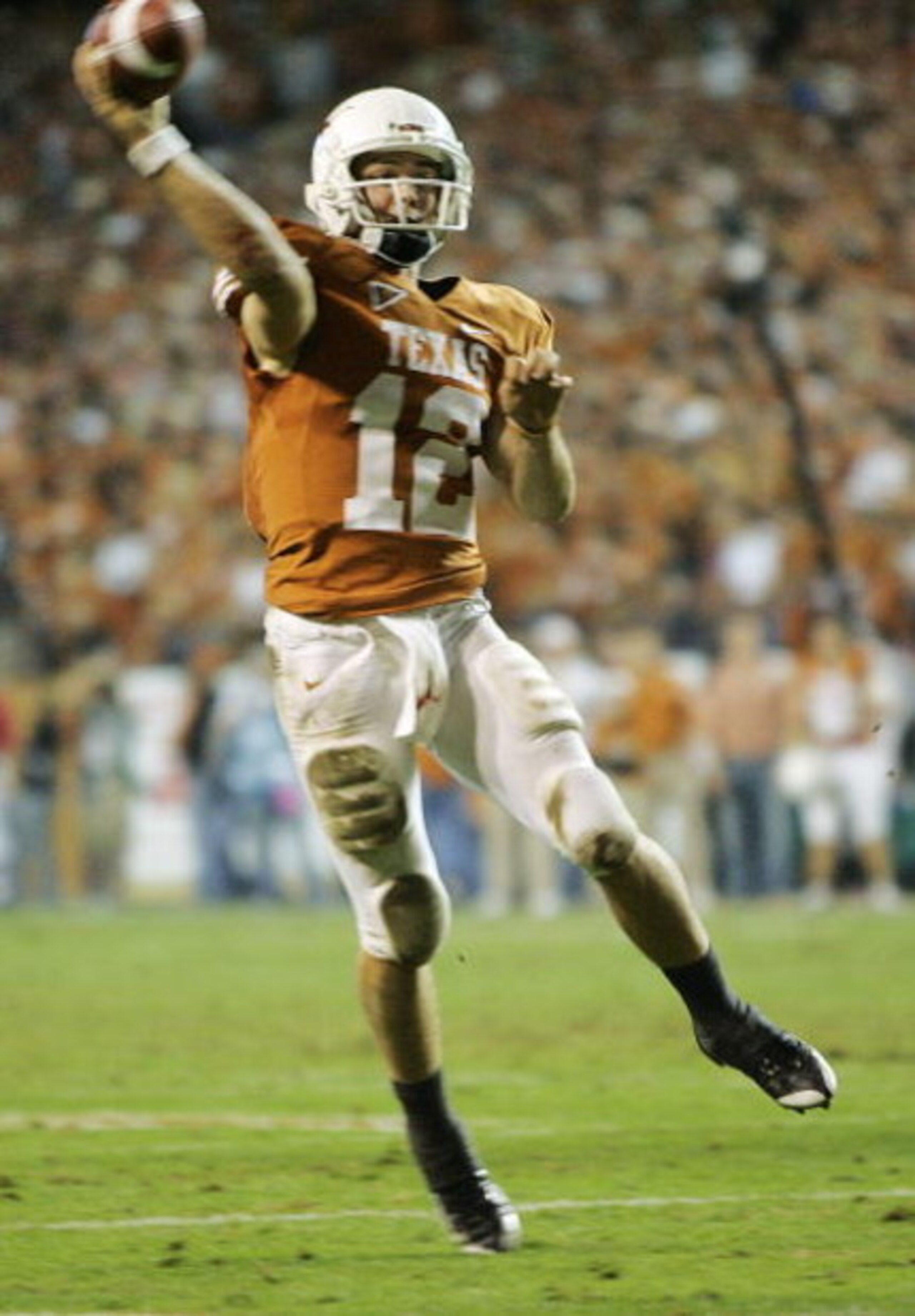 AUSTIN, TX - NOVEMBER 27:  Quarterback Colt McCoy #12 of the Texas Longhorns throws a touchdown to teammate wide receiver Quan Cosby #6 against the Texas A&M Aggies in the final minute of the second quarter at Darrell K Royal-Texas Memorial Stadium Novemb