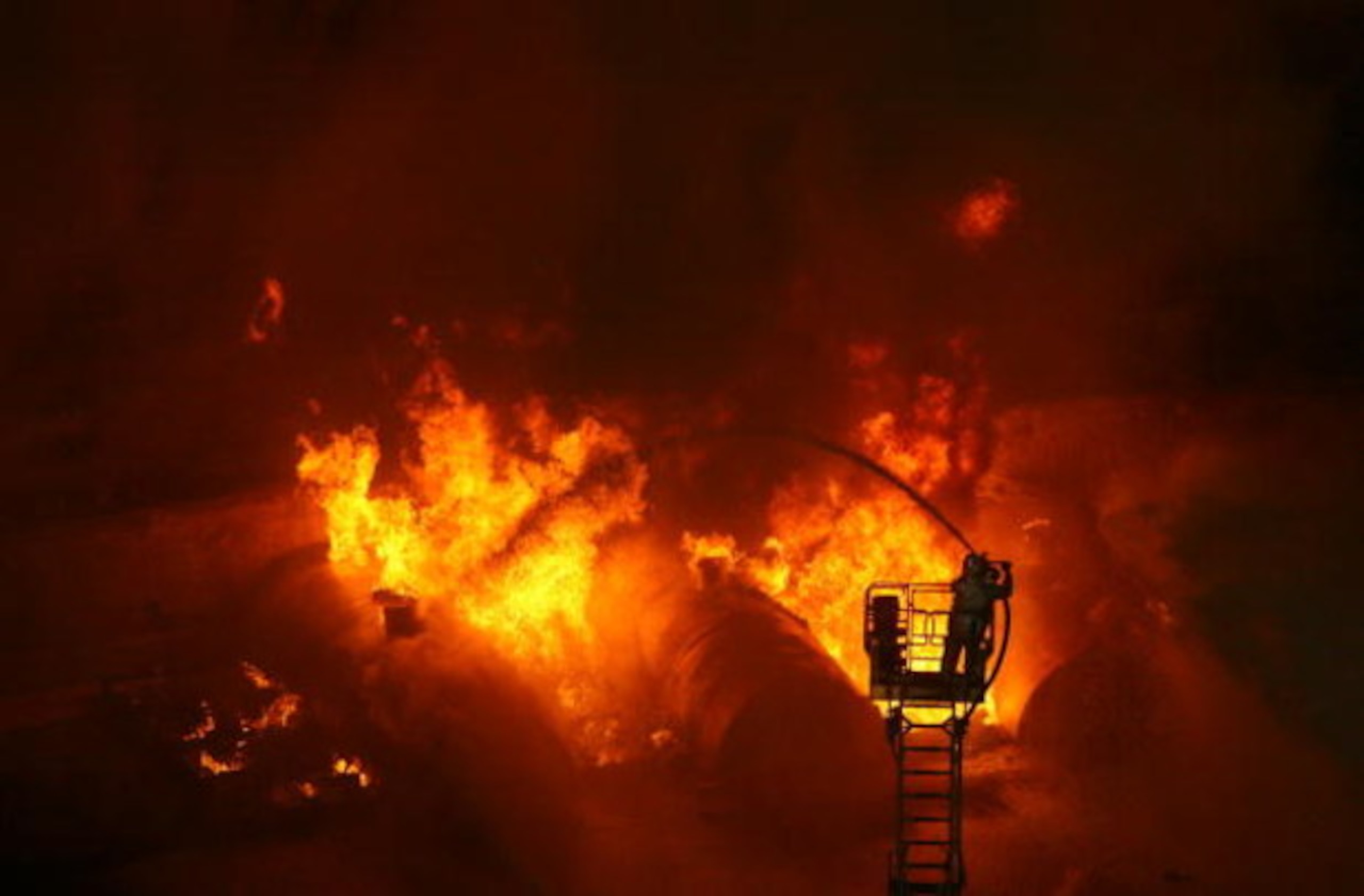 CHONGQING, CHINA - JULY 2: (CHINA OUT) Firemen put out a blaze during an anti-terror drill themed 'To Welcome Olympic Games,To Ensure the Security' at Datianwan Stadium on July 2, 2008 in Chongqing Municipality, China. China has launched a series of anti- CHONGQING, CHINA - JULY 2: (CHINA OUT) Firemen put out a blaze during an anti-terror drill themed 'To Welcome Olympic Games,To Ensure the Security' at Datianwan Stadium on July 2, 2008 in Chongqing Municipality, China. China has launched a series of anti-