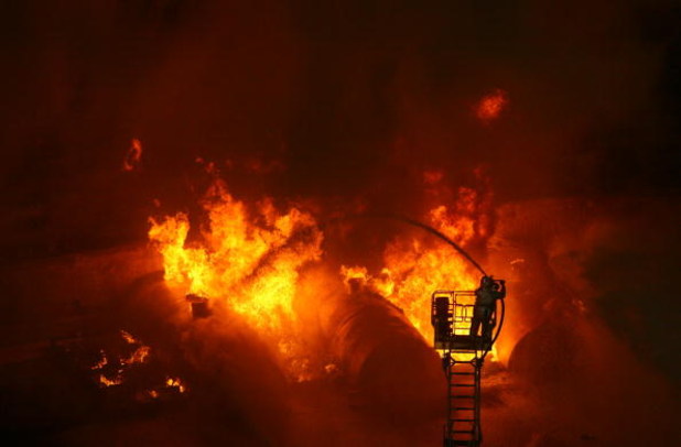 CHONGQING, CHINA - JULY 2: (CHINA OUT) Firemen put out a blaze during an anti-terror drill themed 'To Welcome Olympic Games,To Ensure the Security' at Datianwan Stadium on July 2, 2008 in Chongqing Municipality, China. China has launched a series of anti-