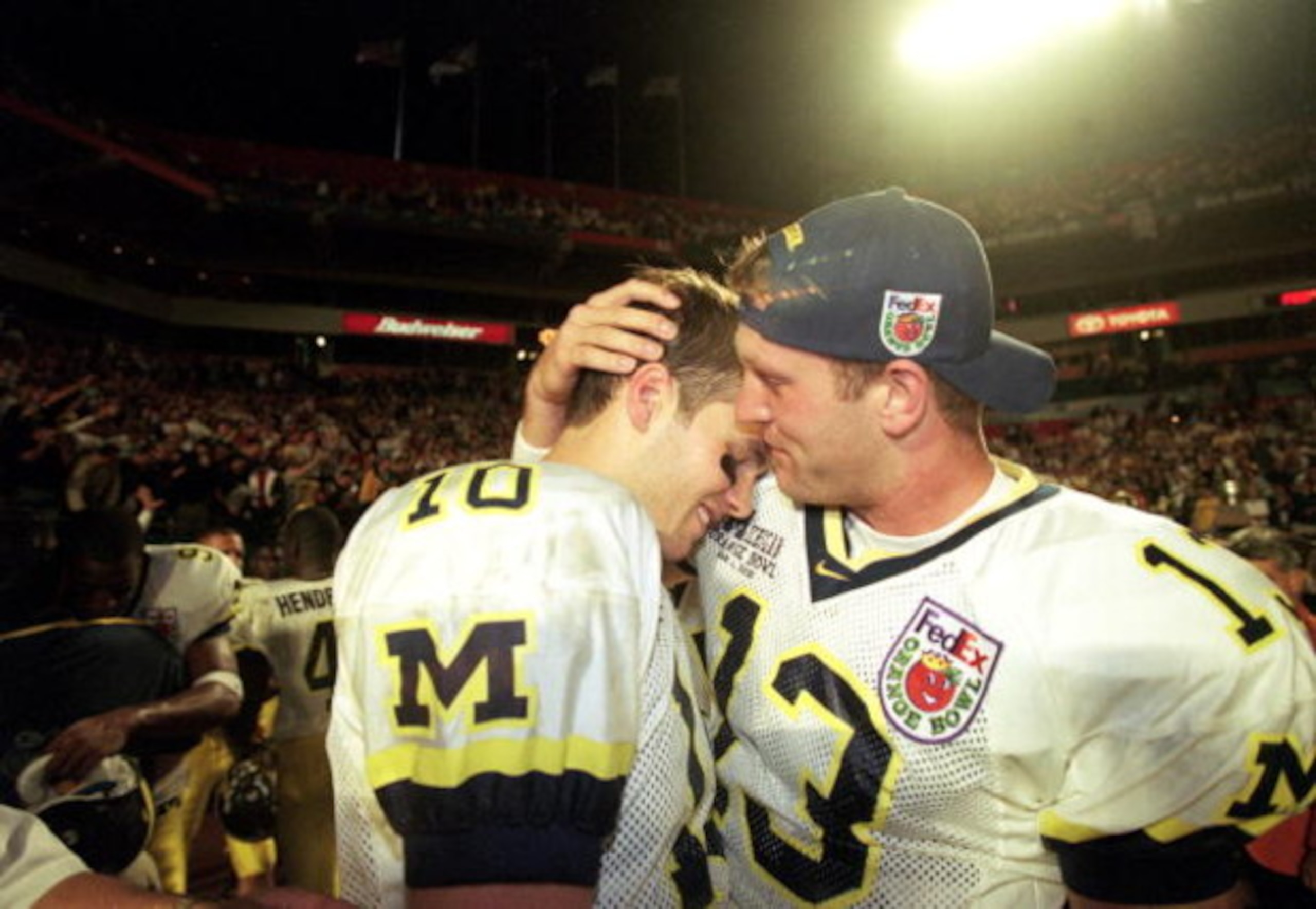 1 Jan 2000:  Tom Bradly and Jason Kapner of the Michigan Wolverines celebrate after winning the Orange Bowl Game against the Alabama Crimson Tide at the Pro Player Stadium in Miami, Florida. The Wolverines defeated the Crimson Tide 35-34. Mandatory Credit