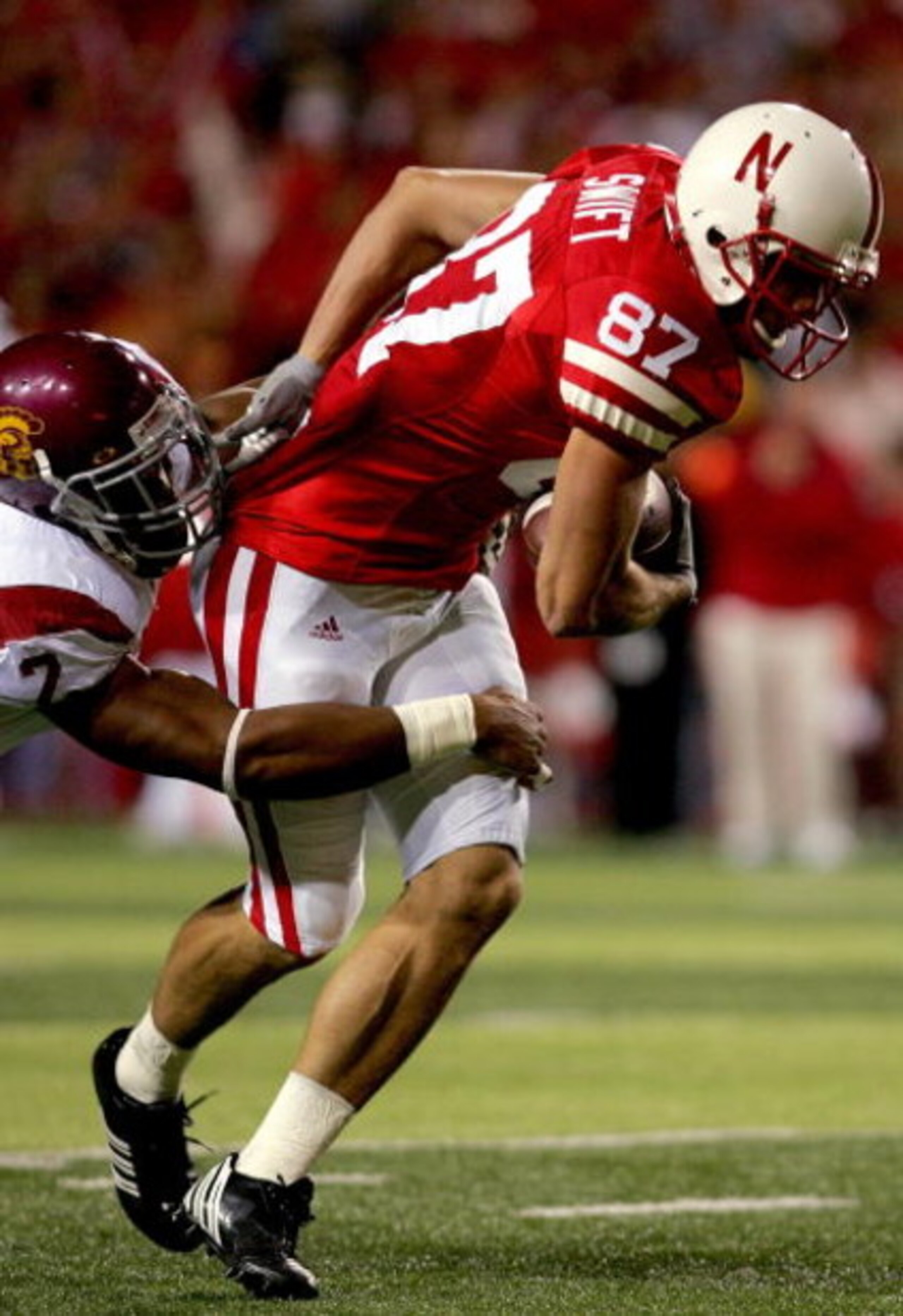 LINCOLN, NE - SEPTEMBER 15:  Nate Swift #87 of the Nebraska Cornhuskers attempts to break free from Taylor Mays #2 of the USC Trojans on September 15, 2007 at Memorial Stadium in Lincoln, Nebraska.  (Photo by Matthew Stockman/Getty Images)