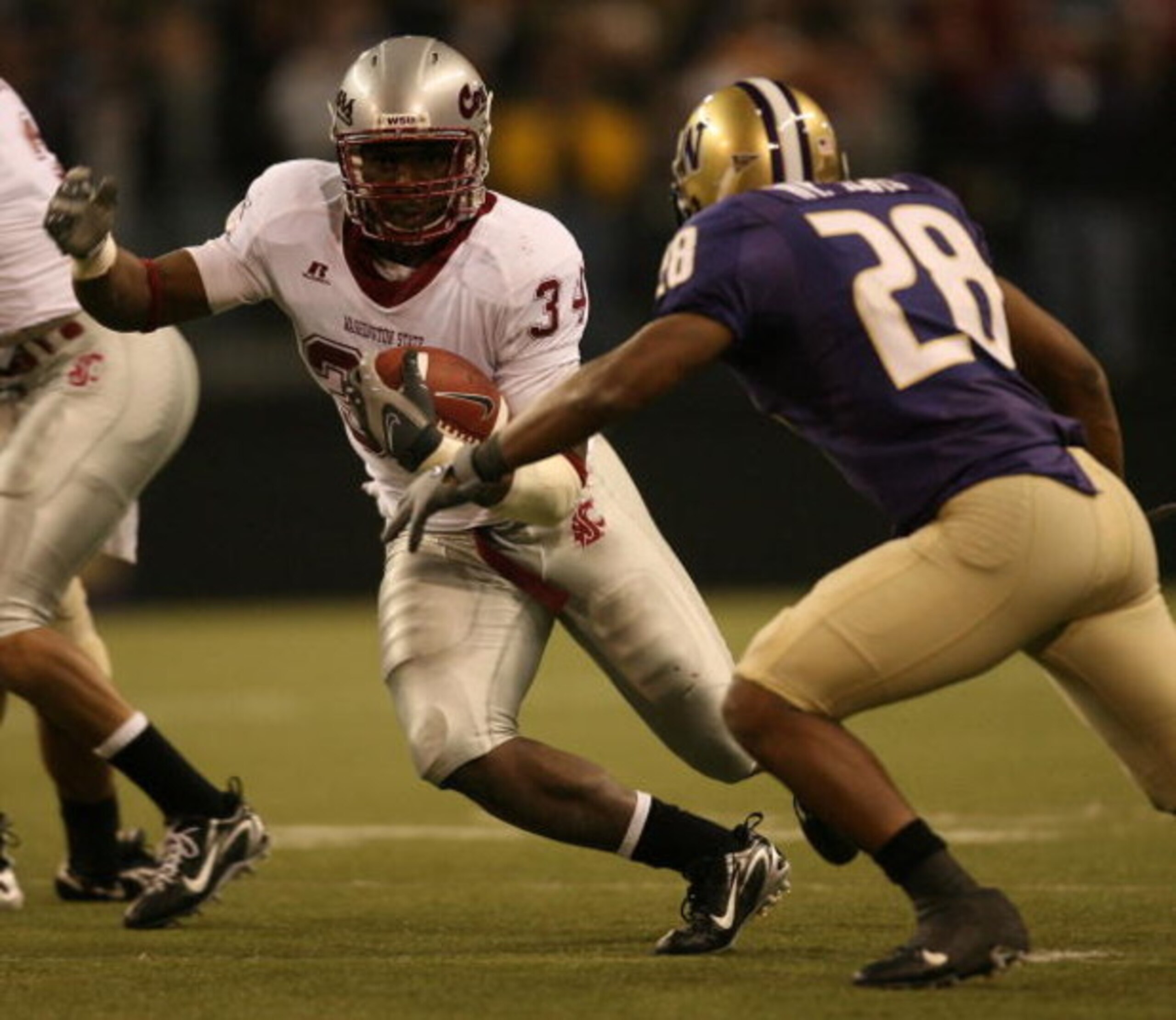 SEATTLE - NOVEMBER 24:  Running back Chris Ivory #34 of the Washington State Cougars rushes against Roy Lewis #28 of the Washington Huskies at Husky Stadium on November 24, 2007 in Seattle, Washington. (Photo by Otto Greule Jr/Getty Images)