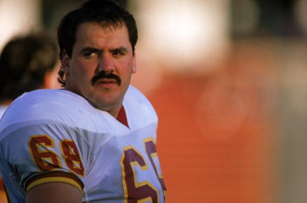 LOS ANGELES - OCTOBER 29:  Offensive linebacker Russ Grimm #68 of the Washington Redskins sits on the sideline during a game against the Los Angeles Raiders on October 29, 1989 at the Memorial Coliseum in Los Angeles, California. The Raiders won 37-24. (P