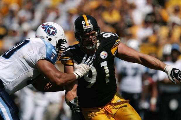 PITTSBURGH - SEPTEMBER 11:  Defensive end Aaron Smith #91 of the Pittsburgh Steelers tries to get around tackle Jacob Bell #60 of the Tennessee Titans during a game at Heinz Field on September 11, 2005 in Pittsburgh, Pennsylvania.  The Steelers defeated t