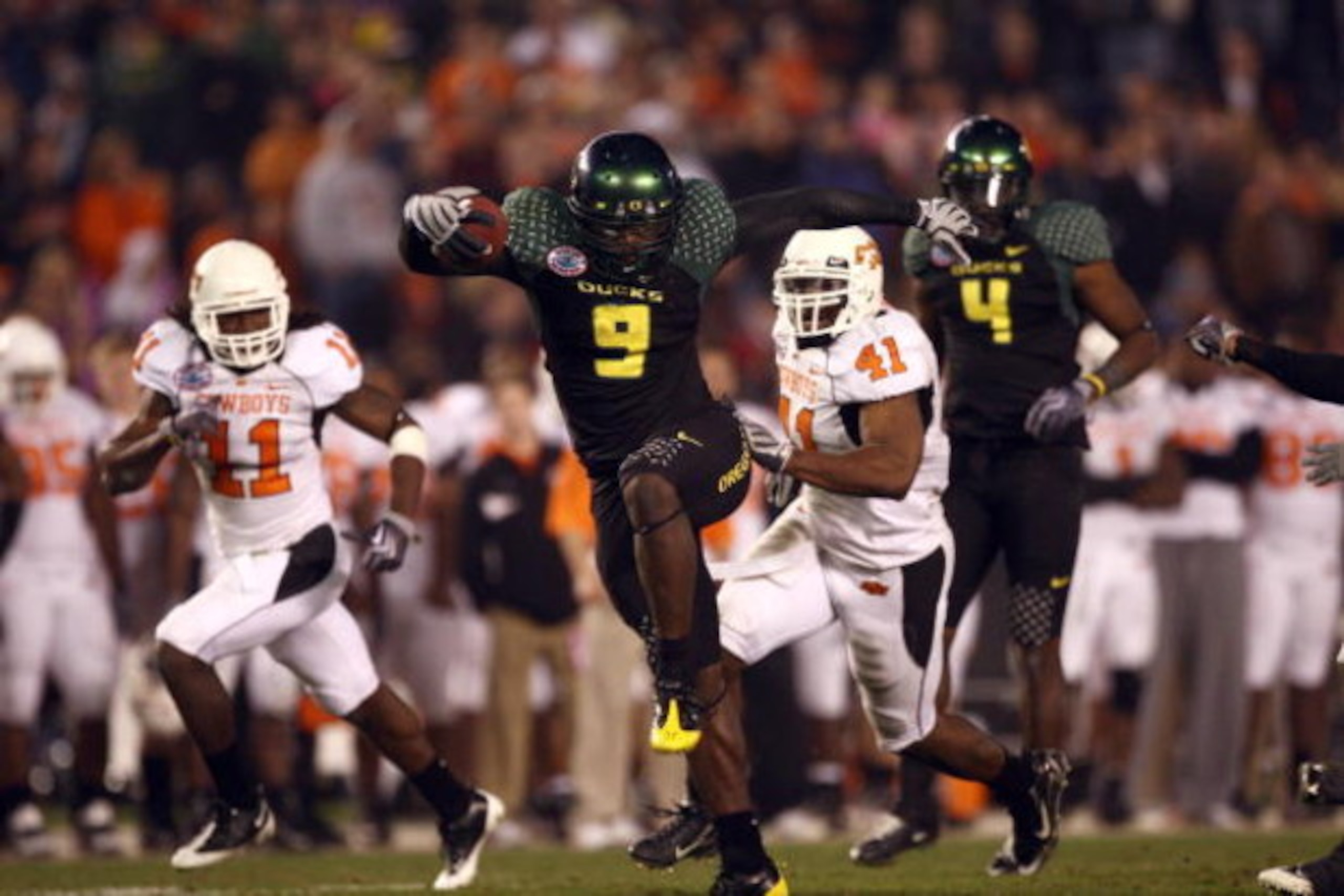 SAN DIEGO, CA - DECEMBER 30:   Runningback LeGarrette Blount #9 of the University of Oregon Ducks hurdles a player en route to a touchdown during his team's 42-31 win over the Oklahoma State University Cowboys in the Pacific Life Holiday Bowl at Qualcomm 