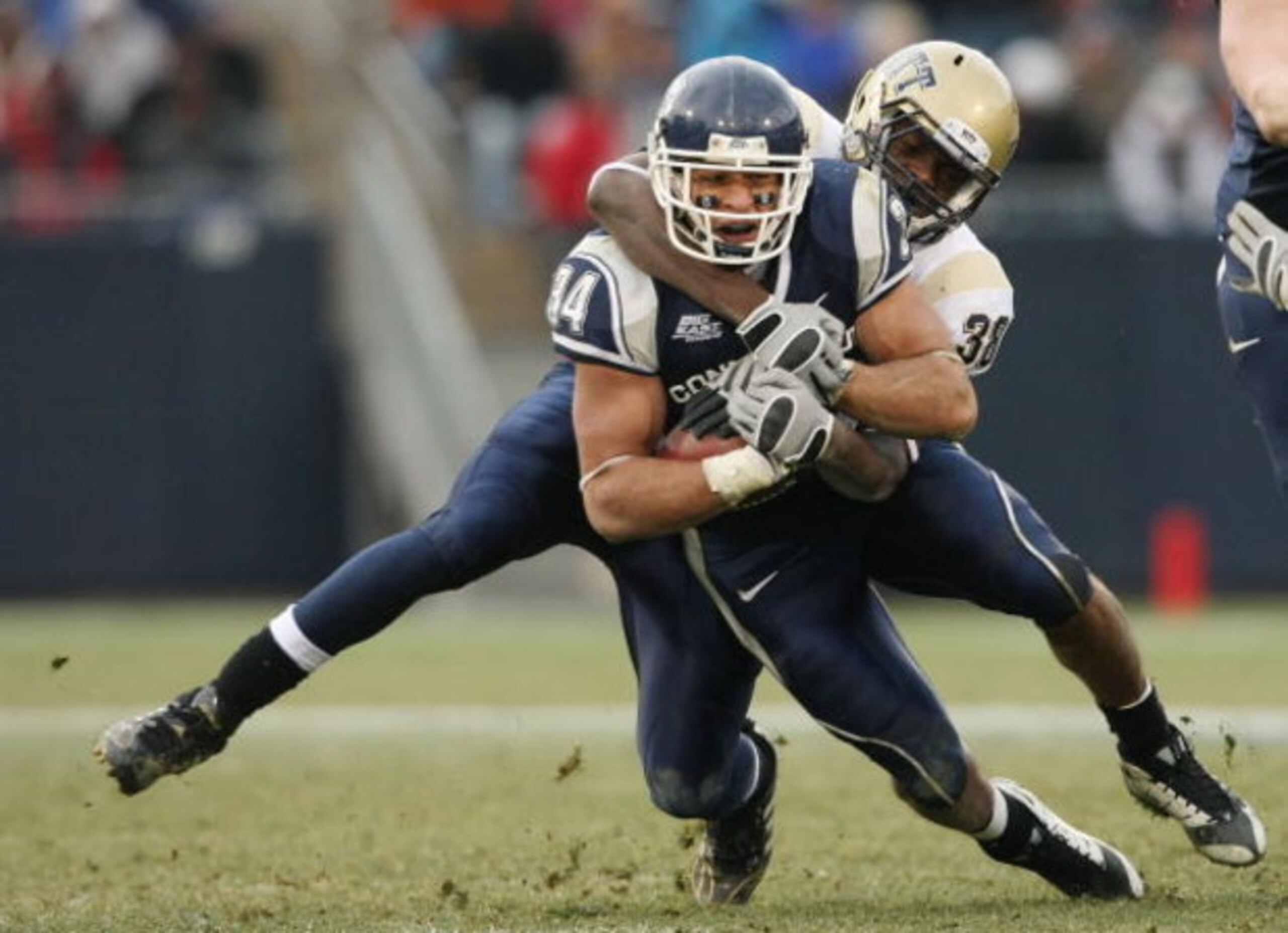 EAST HARTFORD, CT - DECEMBER 06: Donald Brown #34 of the Connecticut Huskies is taken down by Greg Williams #38 of the Pittsburgh Panthers on December 6, 2008 at Rentschler Field in East Hartford, Connecticut. Pittsburgh defeated Connecticut 34-10. (Pho EAST HARTFORD, CT - DECEMBER 06: Donald Brown #34 of the Connecticut Huskies is taken down by Greg Williams #38 of the Pittsburgh Panthers on December 6, 2008 at Rentschler Field in East Hartford, Connecticut. Pittsburgh defeated Connecticut 34-10. (Pho