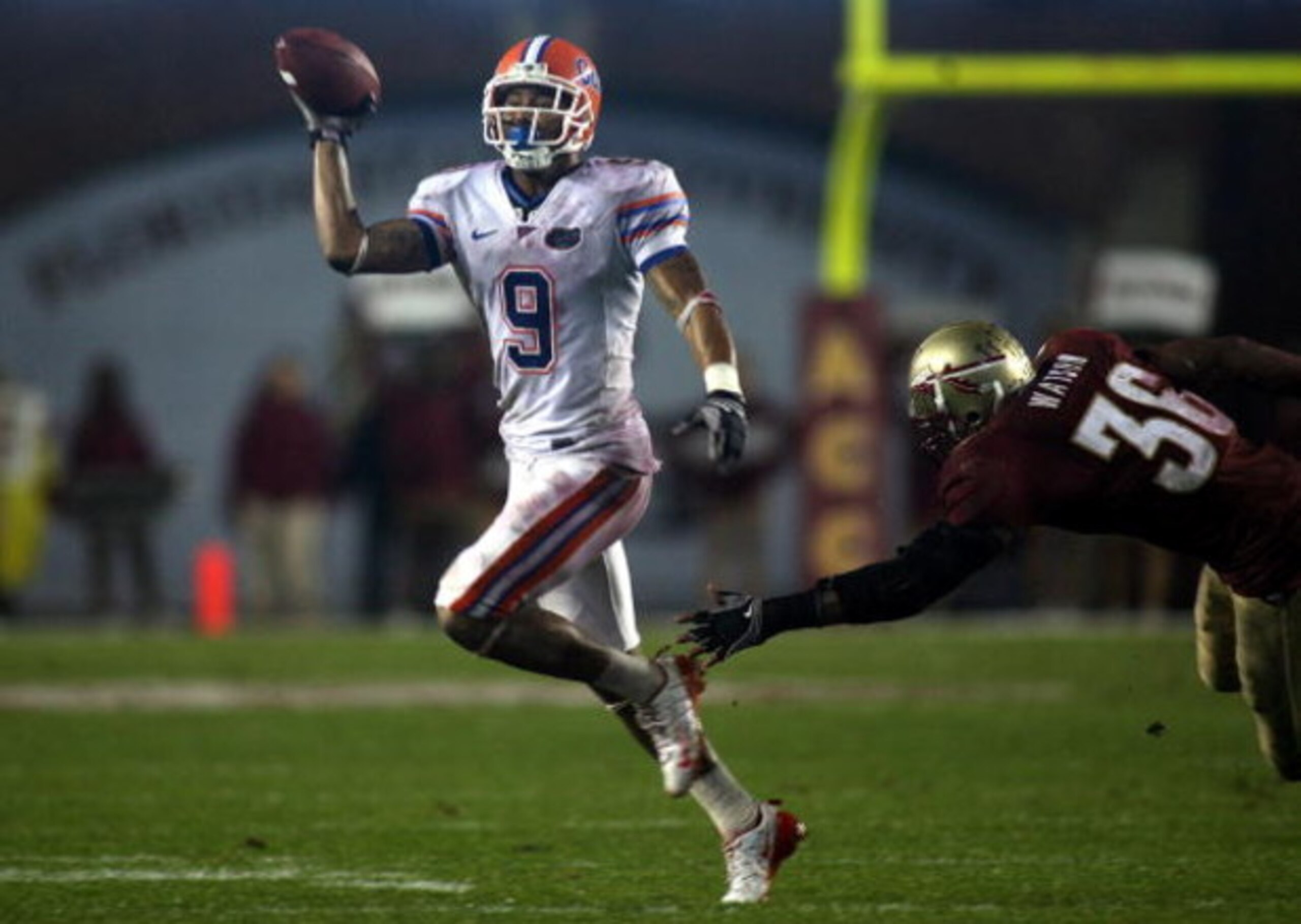 TALLAHASSEE, FL - NOVEMBER 29: Receiver Louis Murphy #9 of the Florida Gators throws the ball against linebacker Dekoda watson #36 of the Florida State Seminoles during the first half at Bobby Bowden Field at Doak Campbell Stadium on November 29, 2008 in TALLAHASSEE, FL - NOVEMBER 29: Receiver Louis Murphy #9 of the Florida Gators throws the ball against linebacker Dekoda watson #36 of the Florida State Seminoles during the first half at Bobby Bowden Field at Doak Campbell Stadium on November 29, 2008 in
