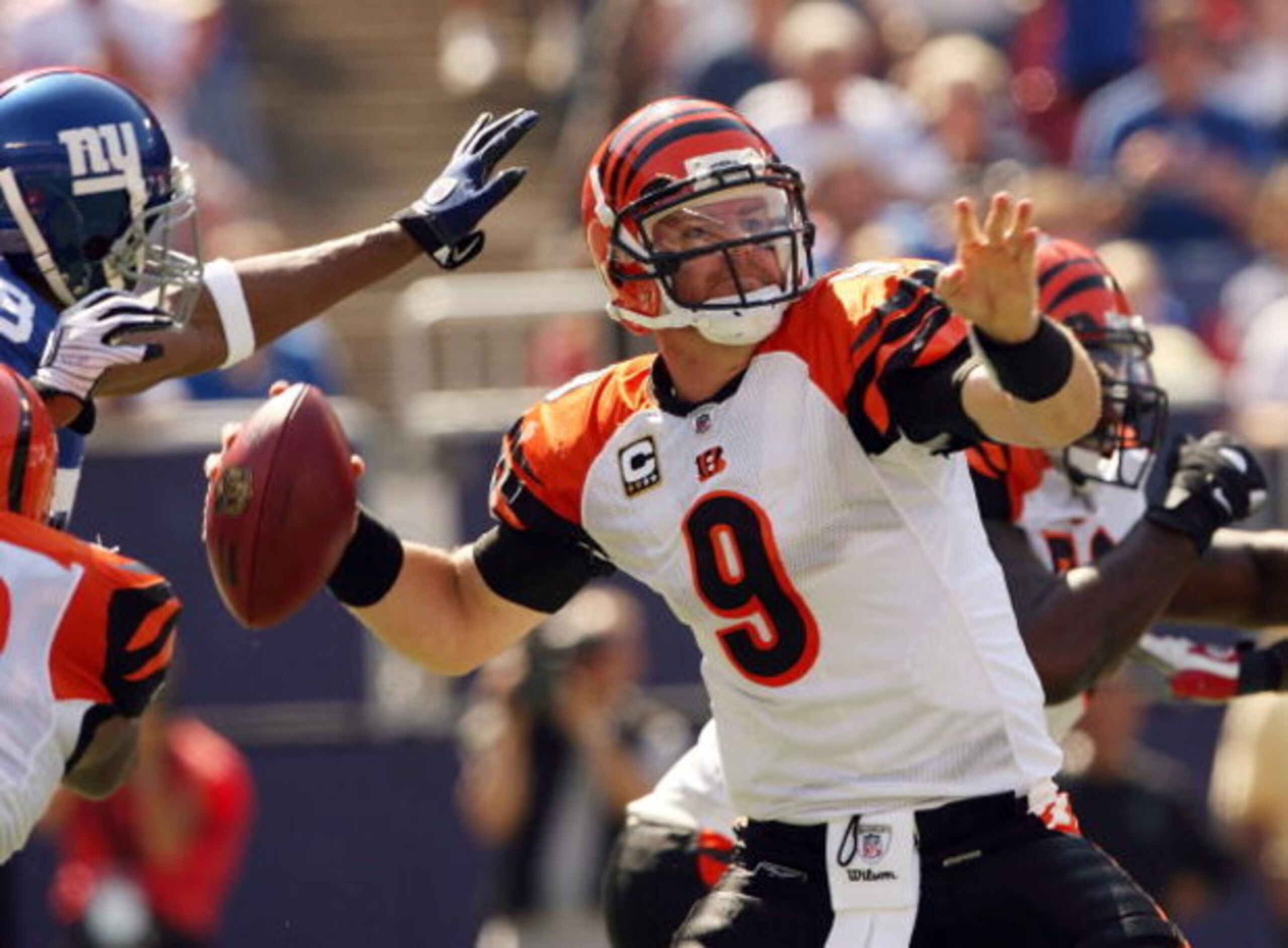 EAST RUTHERFORD, NJ - SEPTEMBER 21:  Carson Palmer #9 of the Cincinnati Bengals looks to pass as he is pressured by the New York Giants defense on September 21, 2008 at Giants Stadium in East Rutherford, New Jersey  (Photo by Elsa/Getty Images)